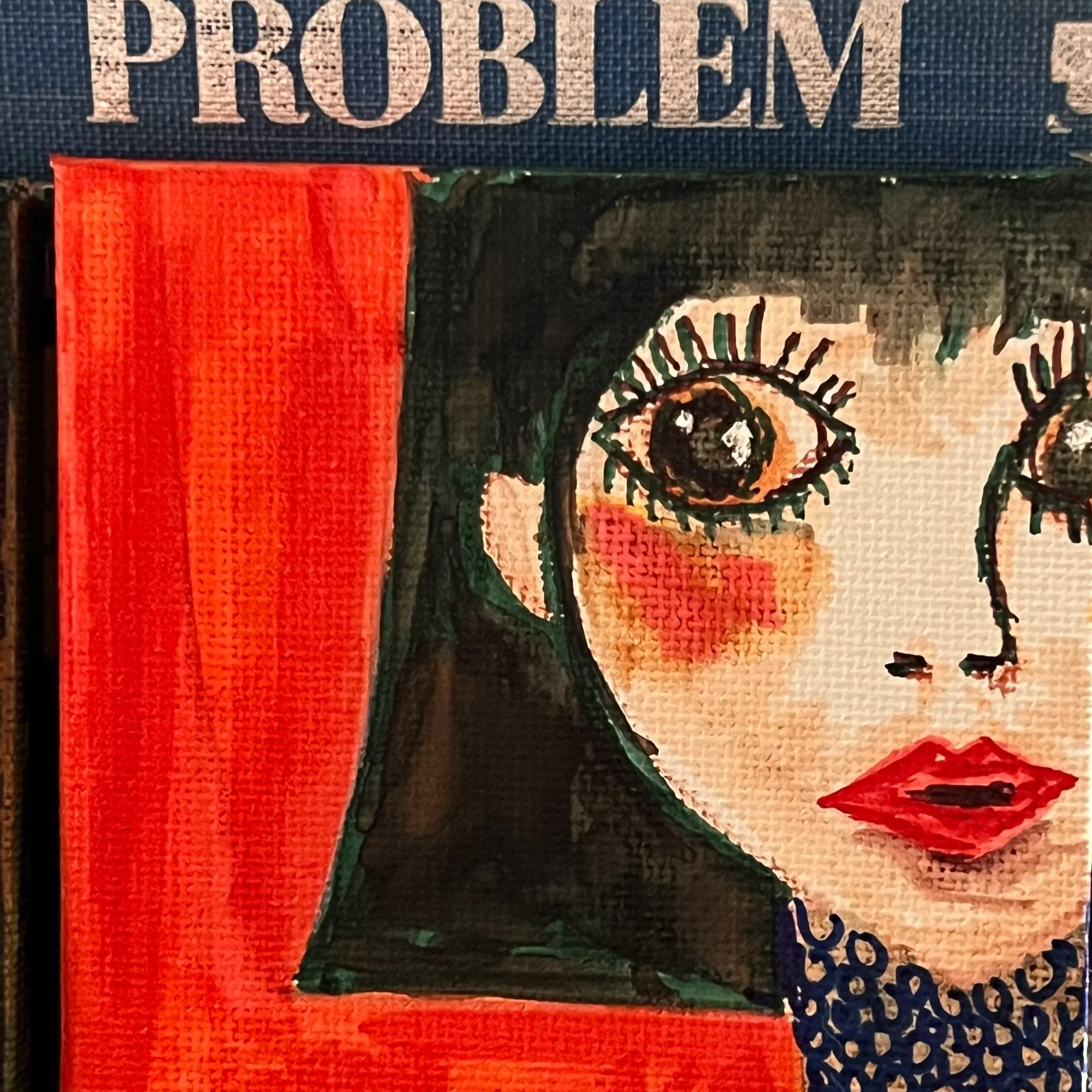 Close-up of a decorative item featuring the word "PROBLEM" in large letters at the top, a red textured strip on the left, and parts of a design with a black spiral pattern and floral elements on the right.