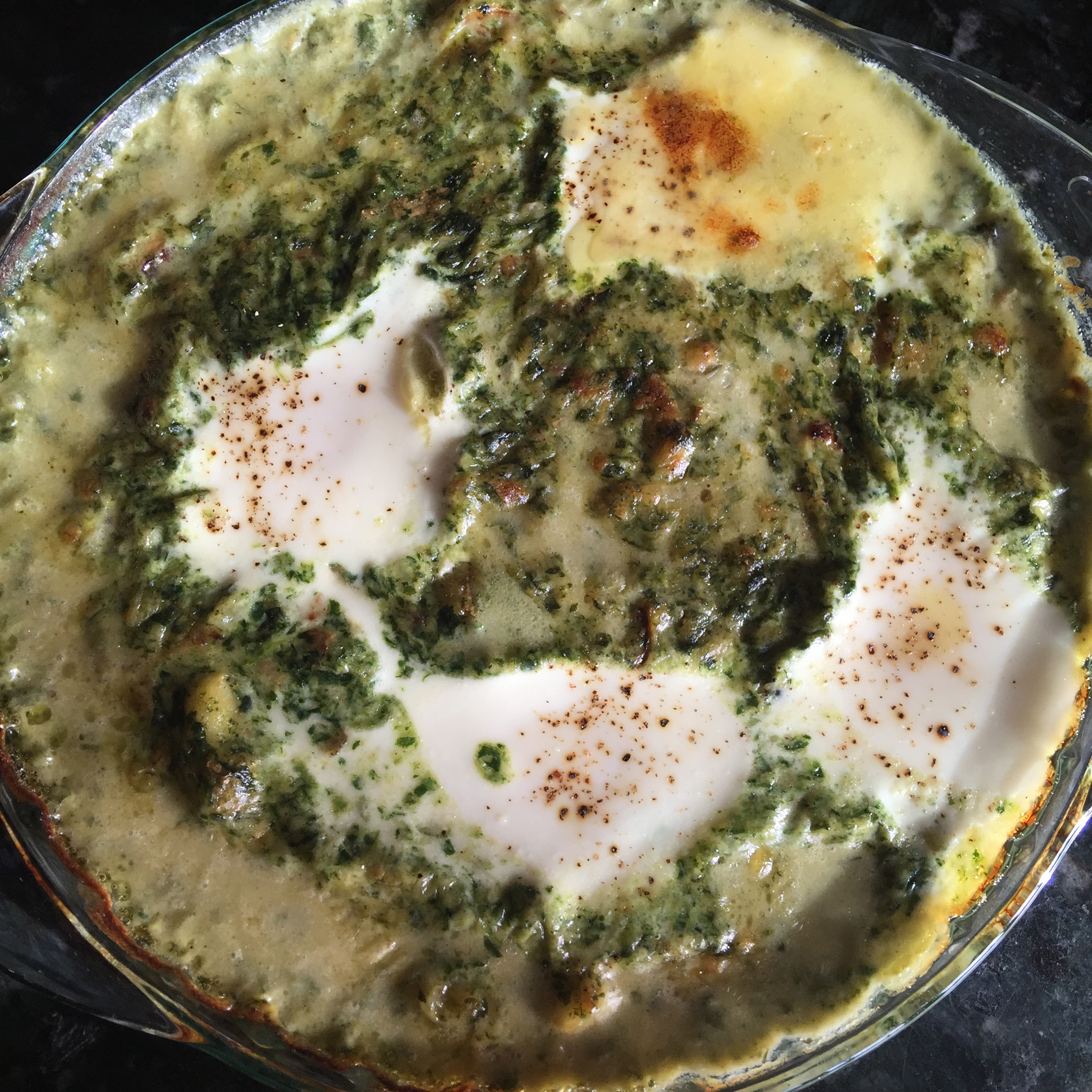 farm eggs baked in creamy spinach