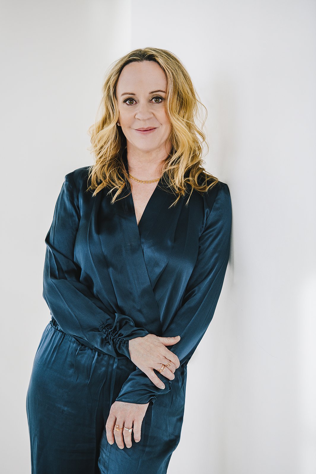 Woman leaning on wall blonde woman personal branding headshots 