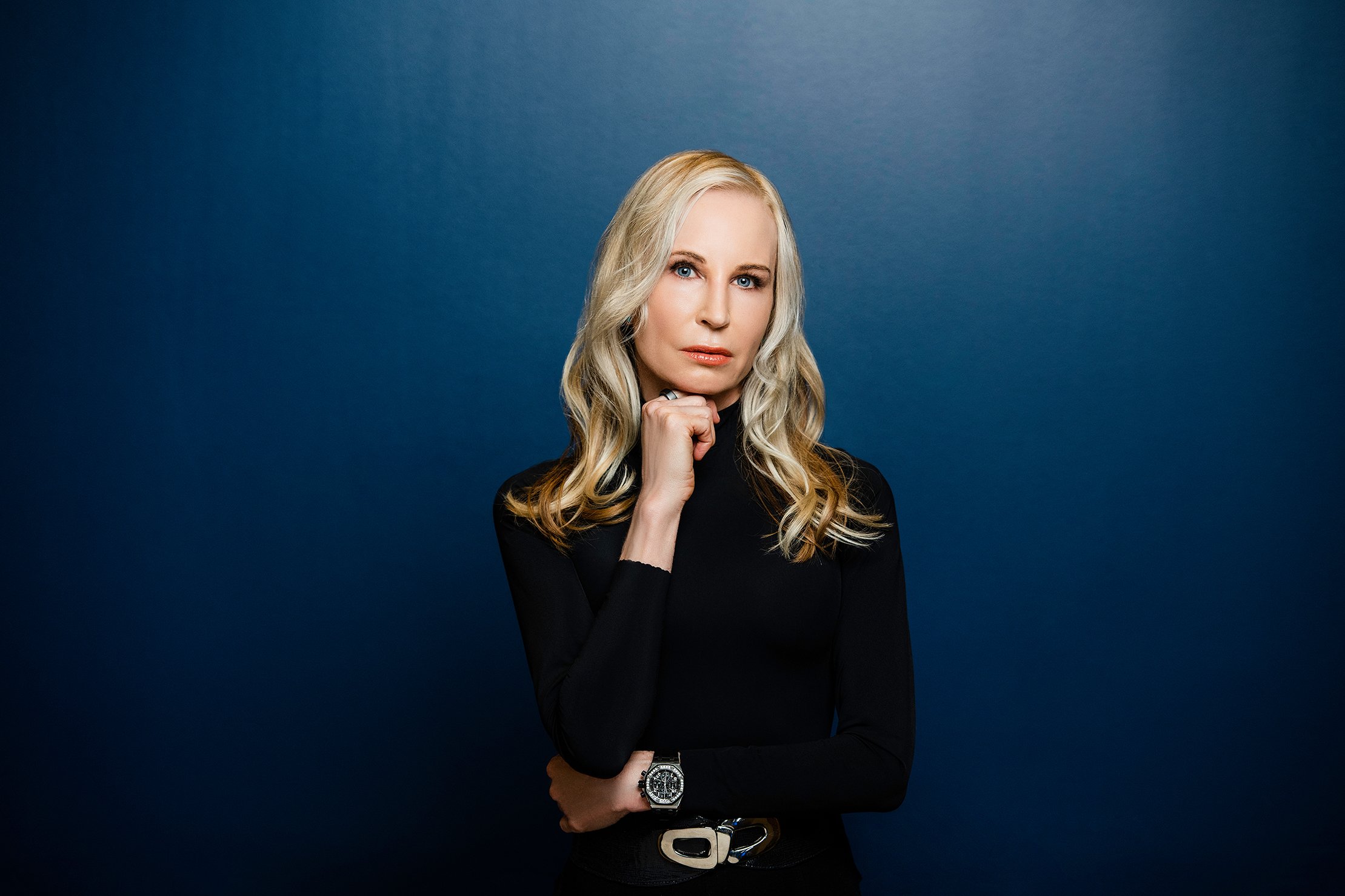 Bold Blue background thinking pose woman studio portraits and headshots