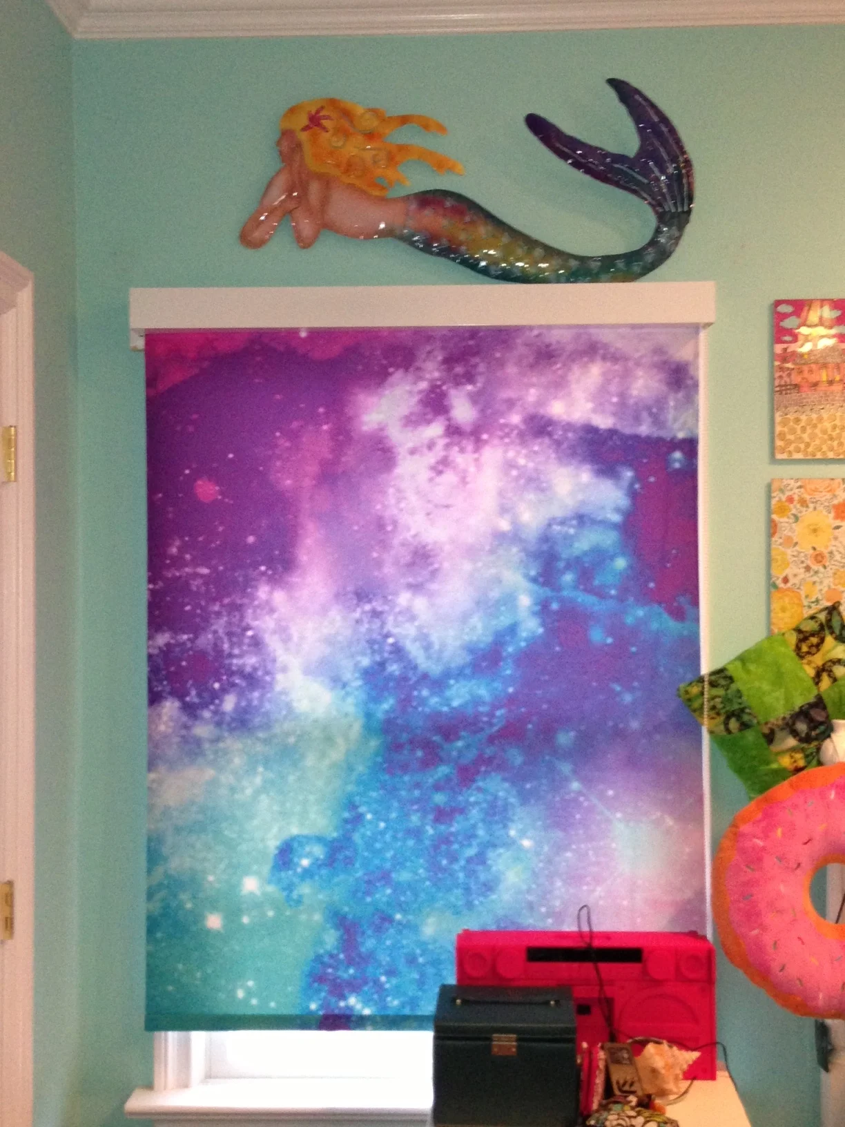 Whimsical, galaxy window shades in child's room. White fascia used to create clean top border.