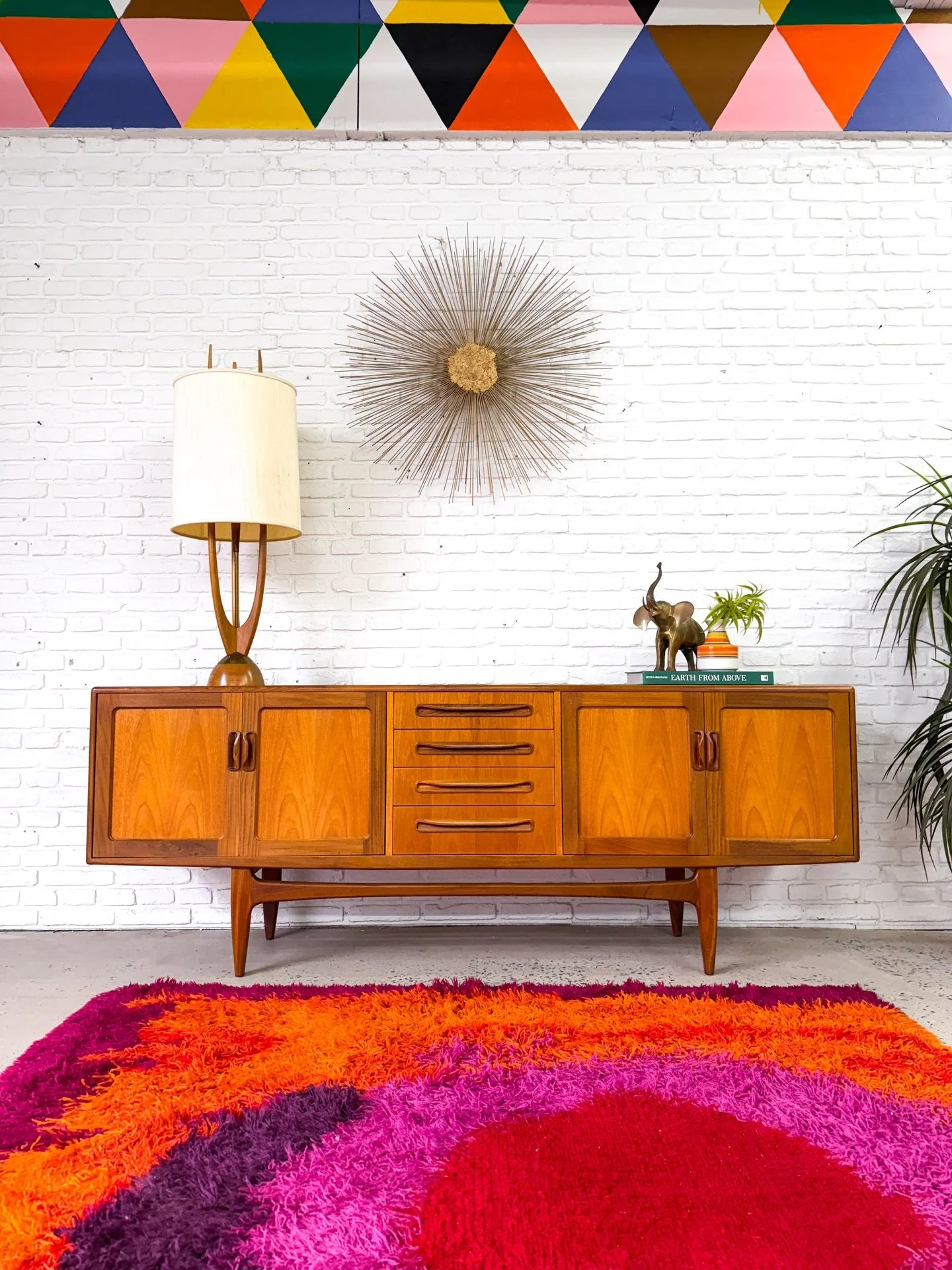 One of the best credenzas out there. The G-Plan teak credenza, made in the United Kingdom in the 1960s. Features those instantly recognizable sculpted pulls.

Tall sculpted solid teak legs, open storage on the sides, and four generous sized drawers i
