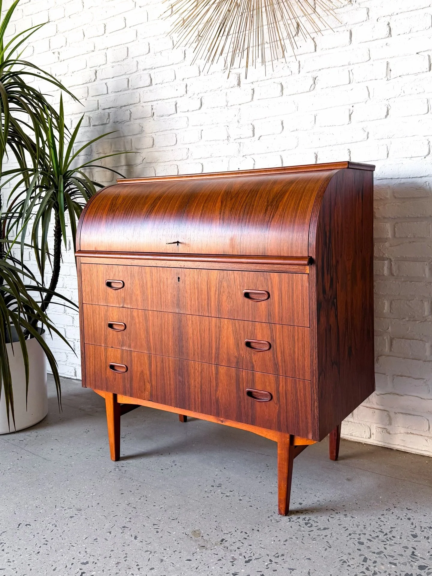 Behold this little cutie! 

Danish rosewood rolltop secretary desk, with three large drawers, a pull out desk surface, and some more little storage inside.

35.25&rdquo; x 18.5&rdquo; x 38.25&rdquo; tall
Desk top: 33.75&rdquo; x 17&rdquo;

Check out 