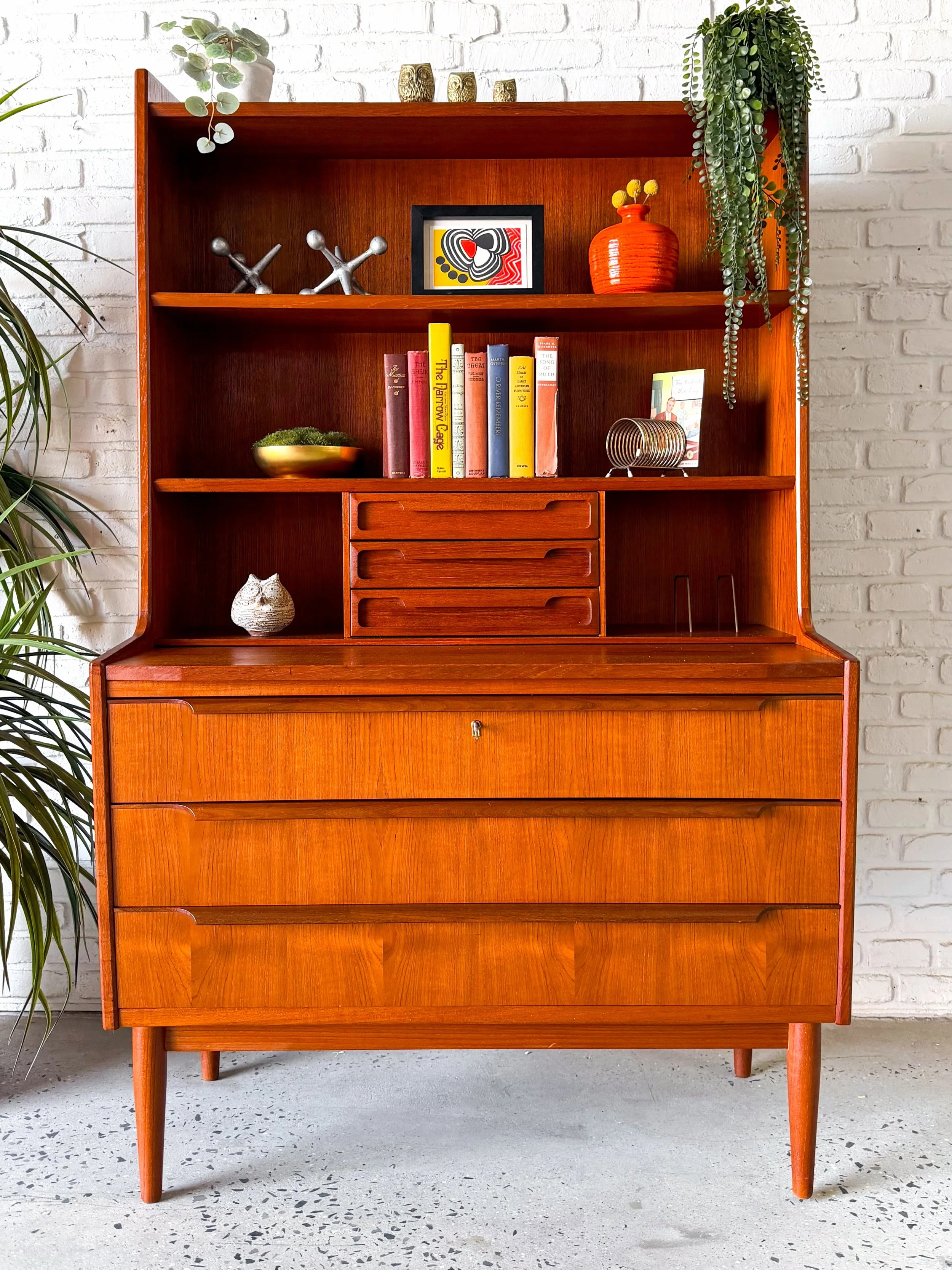 This is a teak secretary desk, made by master cabinet makers in denmark in the 1960s. Slideout desktop for a sleek work-from-home setup that doesn&rsquo;t dominate your space. 

Warm teak exterior and solid birch drawers. 

39&rdquo; x 19&rdquo; x 64