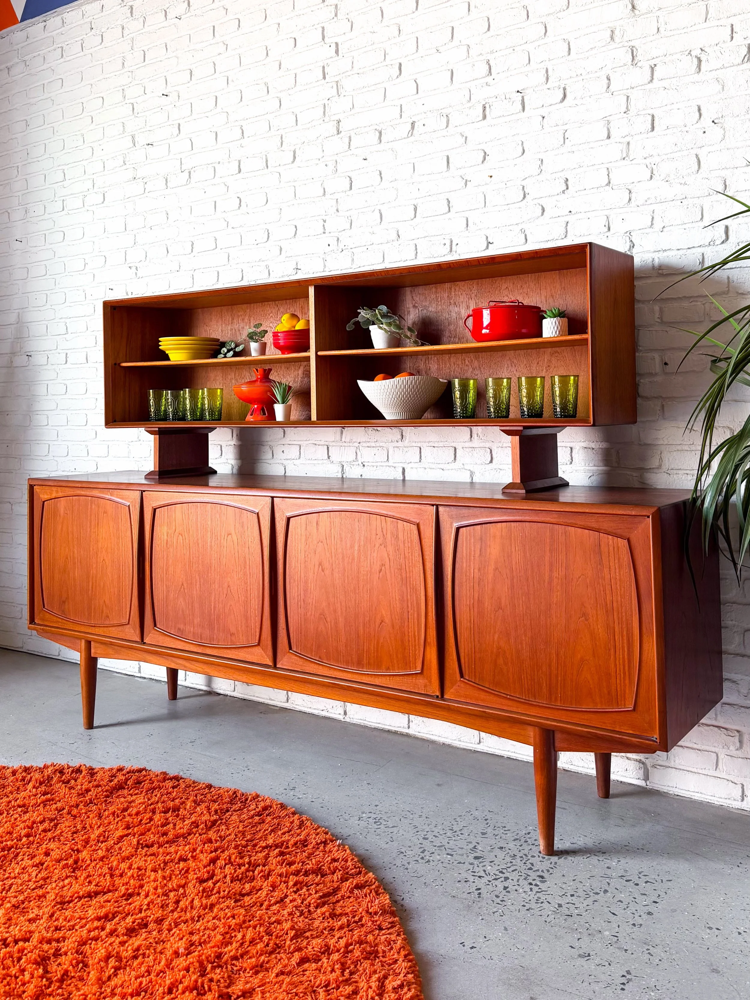 Does it get any better?

Two piece Danish/Norwegian Modern teak hutch from the 1960s. So much storage, both hidden and visible. 

In outstanding original condition. Sliding glass doors have been removed for photos.

The top is actually a different ma