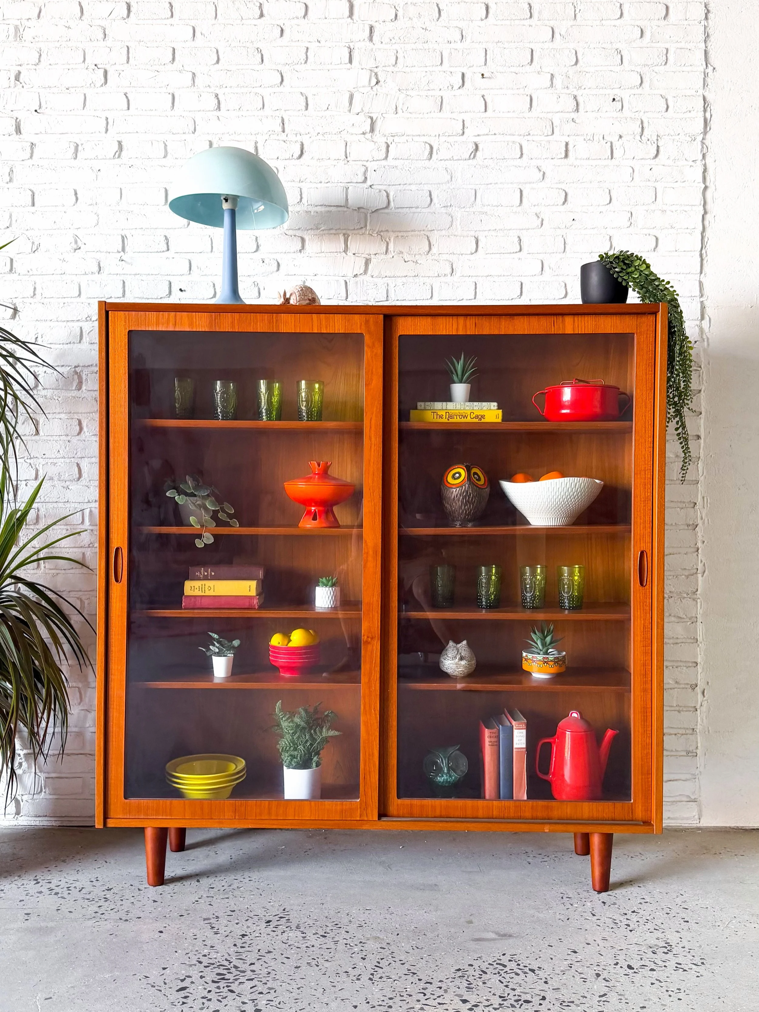 Narrow Danish teak display cabinet bookcase, with sliding glass doors, and adjustable shelves. So good it hurts. 

Designed by Poul Hundevad in Denmark circa 1960s.

$1200 

54.5&rdquo; x 12&rdquo; x 56.75&rdquo; tall

#hundevad #poulhundevad #danish