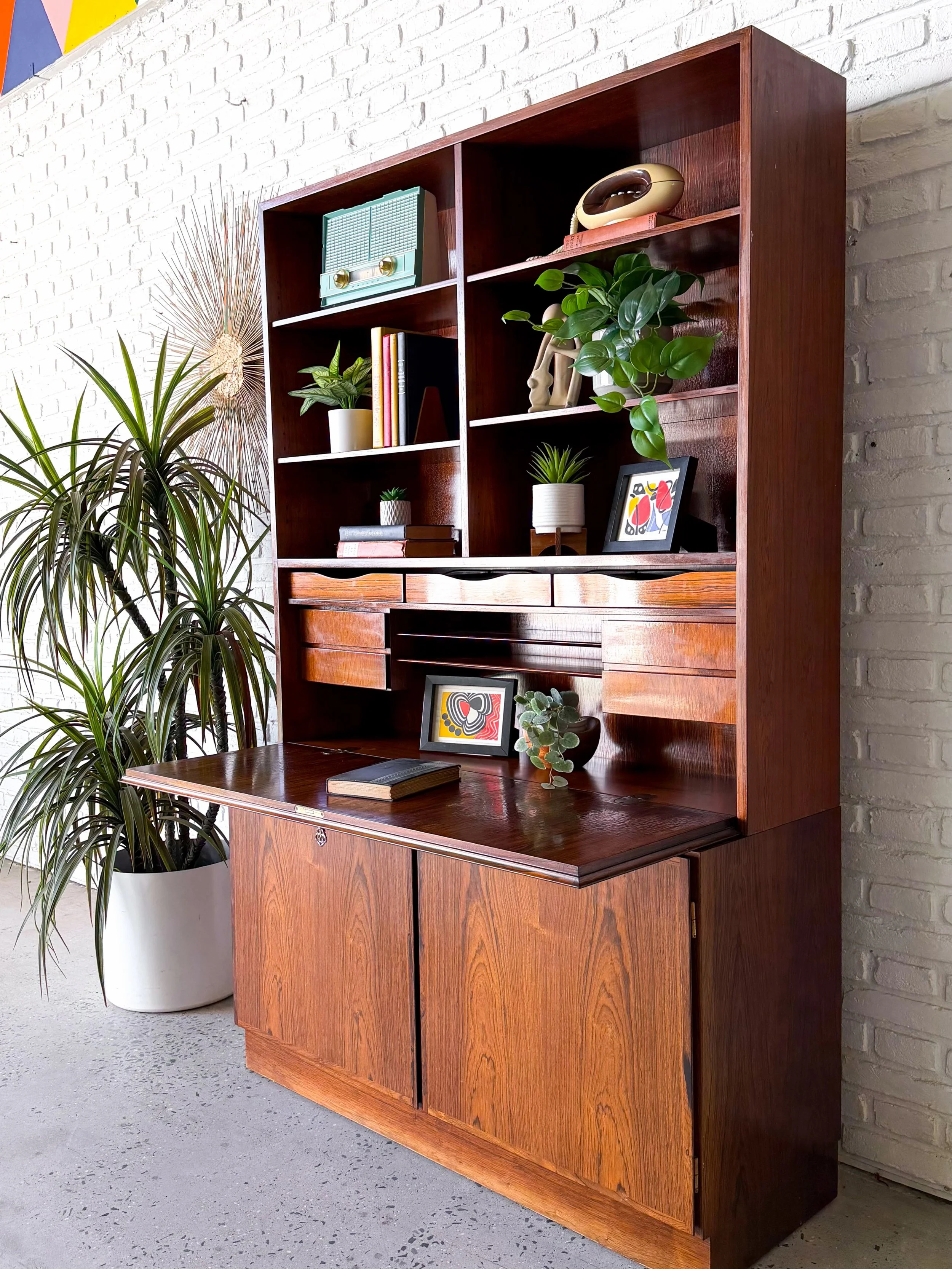 Two piece rosewood drop-down secretary desk, made in Denmark by Omann Jun. 

A perfect work-from-home work station. Drop down work surface, cubbies, hidden shelves, storage, bookshelves. Versatile and useful. 

$2250

47.25&rdquo; x 17.5&rdquo; x 73.