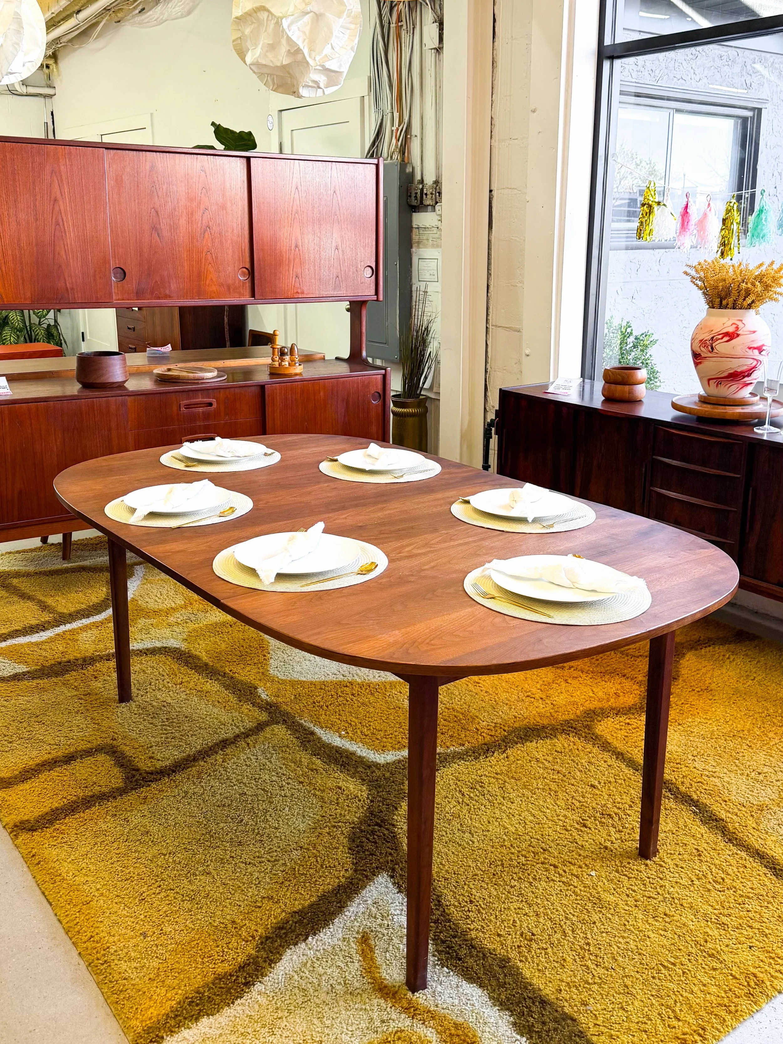 A squircle shaped oiled walnut dining table by Jack Cartwright for Founders from the 1960s. 

Two large leaves open it up to fit all your guests. A clean, simple design. Great original condition. 

45&rdquo; x 45&rdquo; x 29&rdquo; tall
plus two 15&r
