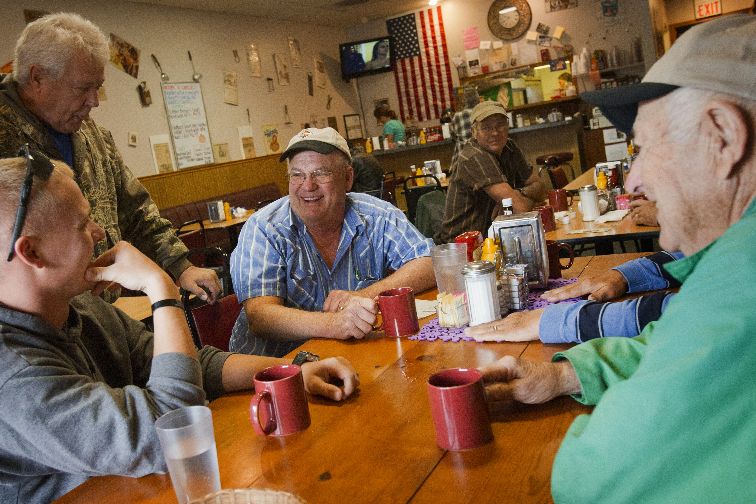  At Janelle's Diner in Pemberville, Ohio, Jim Witker, center, revels in the welcome his fellow dinners give his son, Arik, left, who is home from his latest military tour of duty in Afghanistan. Jim Witker says he feels neither major political party 