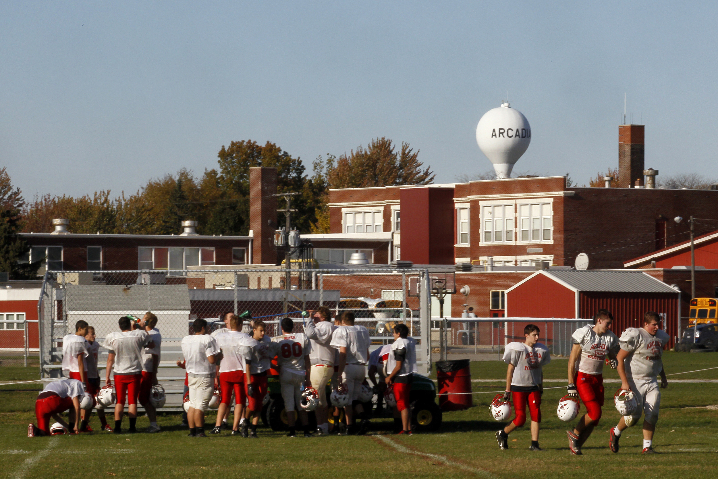  Members of the Arcadia, Ohio, football team head back to the field after a break in practice. The Arcadia elementary, middle and high school grades are housed in one building. With 71 total faculty and staff, the schools are the largest employer in 