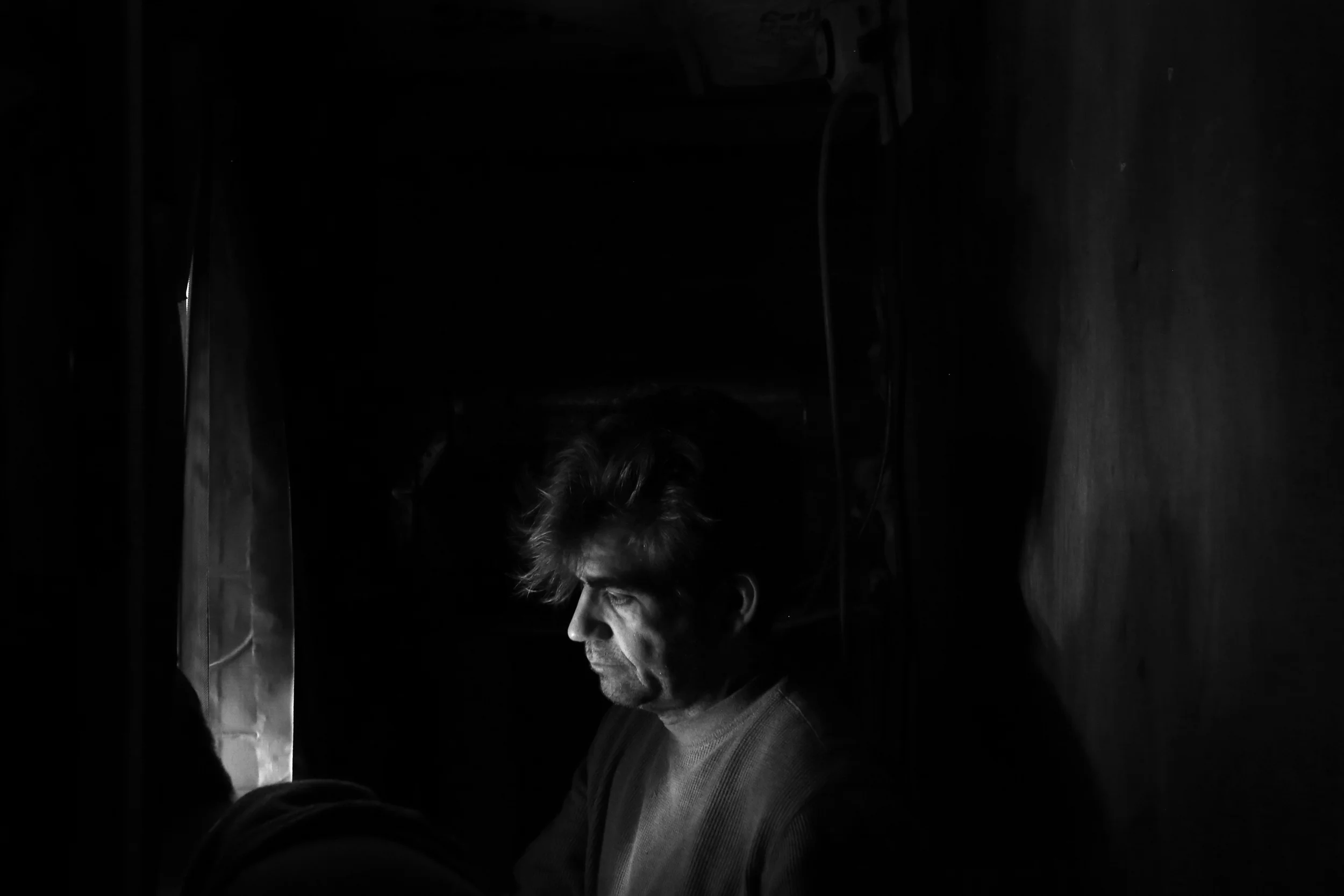  John Evans peers into a makeshift room containing his growing marijuana plants. A proponent and user of medical marijuana, Evans moved to Michigan in 2010 to become a registered care giver, the term used for a legal grower of medical marijuana who s