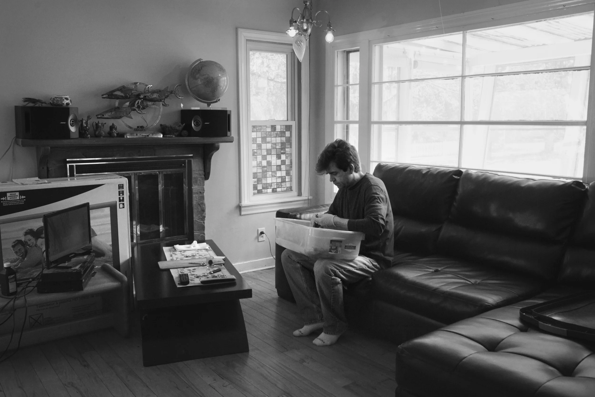  John Evans works with his dried marijuana as he processes the plants for consumption in his living room. A proponent and user of medical marijuana, Evans moved to Michigan in 2010 to become a registered care giver, the term used for a legal grower o