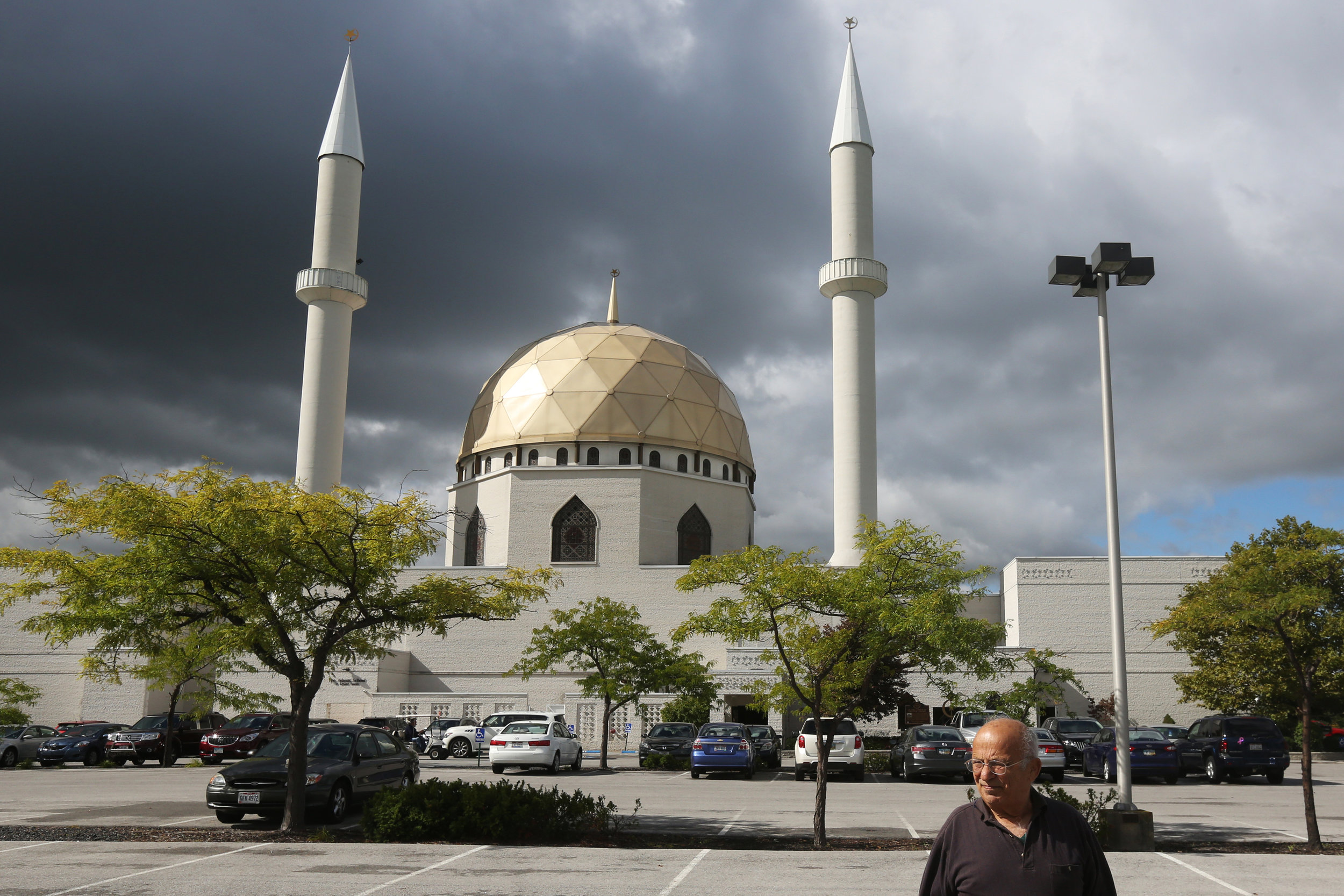  Hassan Cheaib, 81, pauses as he heads in to the Islamic Center of Greater Toledo, located in Perrysburg, for the mosque's International Festival in August, 2014. Hassan emigrated from Lebanon in 1961 and helped pave the way for his immediate and ext