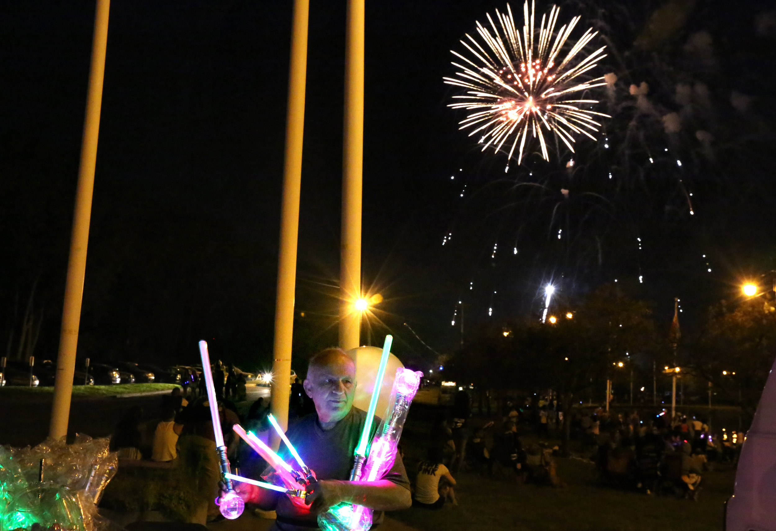  Hassan Cheaib, 81, sells balloons and glow sticks Saturday, July 4, 2015, during The Blade's 2015 Red, White, KABOOM Independence Day event at International Park in East Toledo. As a child, Mr. Cheaib worked as a street vendor in Lebanon to help sup