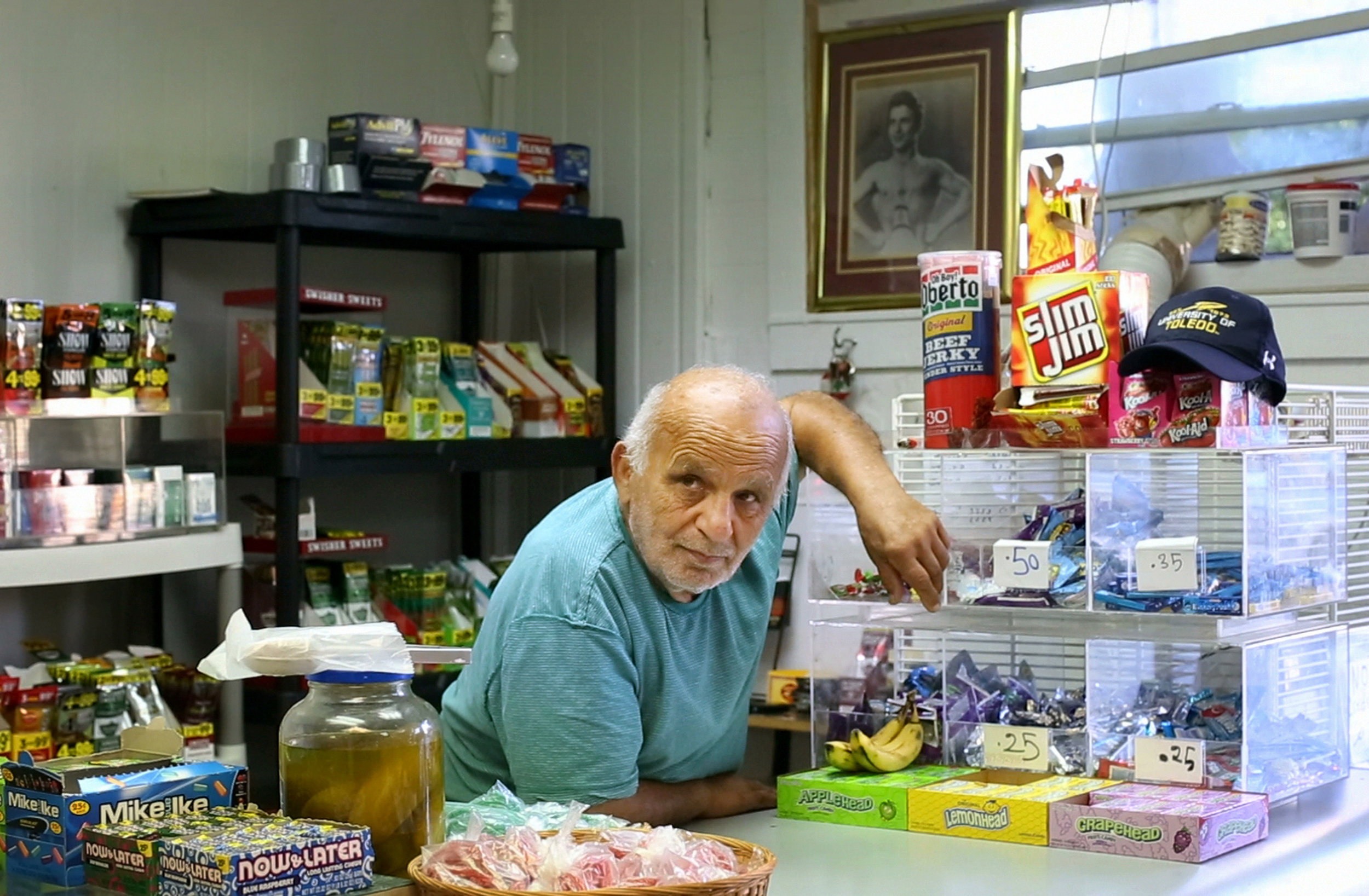  Hassan Cheaib, 81, waits for customers on a warm day in the late summer of 2014 inside his shop in Toledo's North End. Mr. Cheaib has been a resident of North Toledo since the 1960's. He doesn't carry beer or wine at his shop, so many of his custome