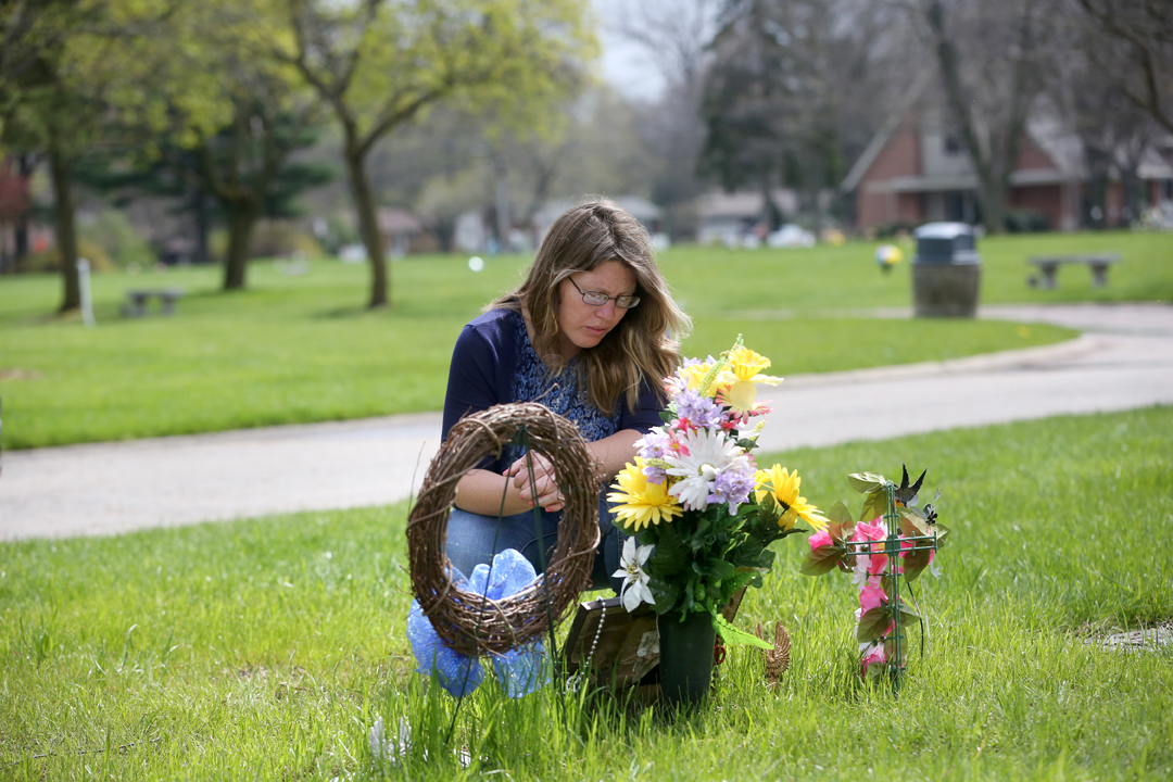  Josianne Thomas kneels at the grave of her two eldest children, Joscelyn and Johnny, who were 16 and 14 when they were murdered in the fall of 2015 by Joscelyn's boyfriend. Josianne survived being stabbed more than a dozen times in the same attack. 