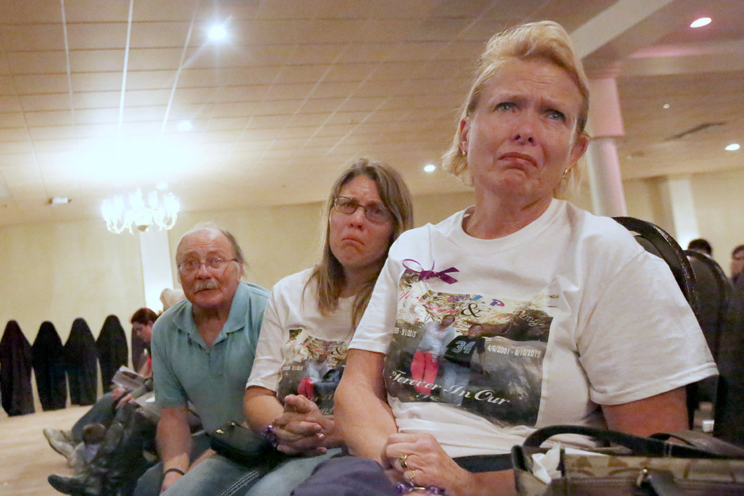  Josianne Thomas, center, her father David Page, left, and her mother Brenda Hendricks, right, cry together as Josianne's daughter, Joscelyn Jones, has her story read aloud at the Northwest Ohio Silent Witness Project Unveiling Ceremony in Maumee, Oh