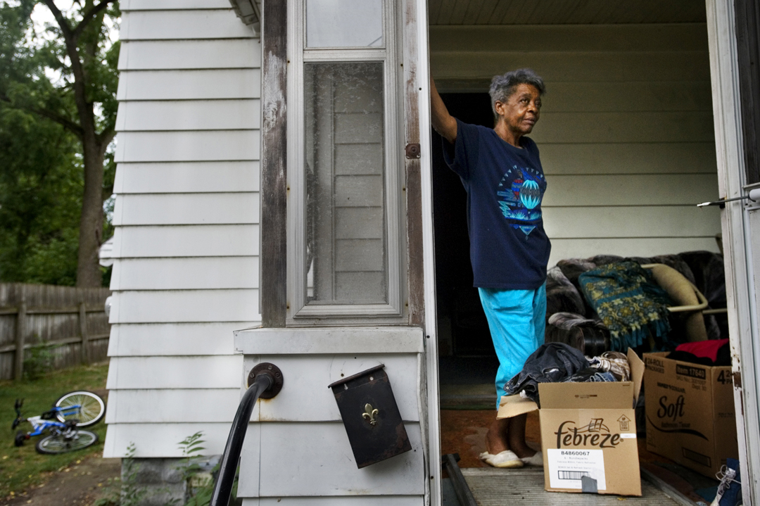  Annie Osborne takes a break in between carting boxes out of her former home in Jackson. Tax foreclosure, an increasingly common issue in Jackson County, often claims homes fully owned by their occupants. Though Annie's family had owned her home outr
