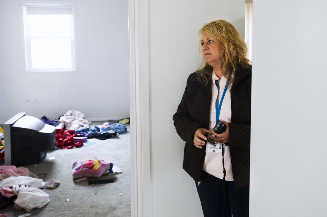  Karen Coffman, Jackson County treasurer, glances around a house filled with the personal effects of the last residents while making the rounds after the yearly tax foreclosure acquisitions by the county. Many people simply leave behind most of the p