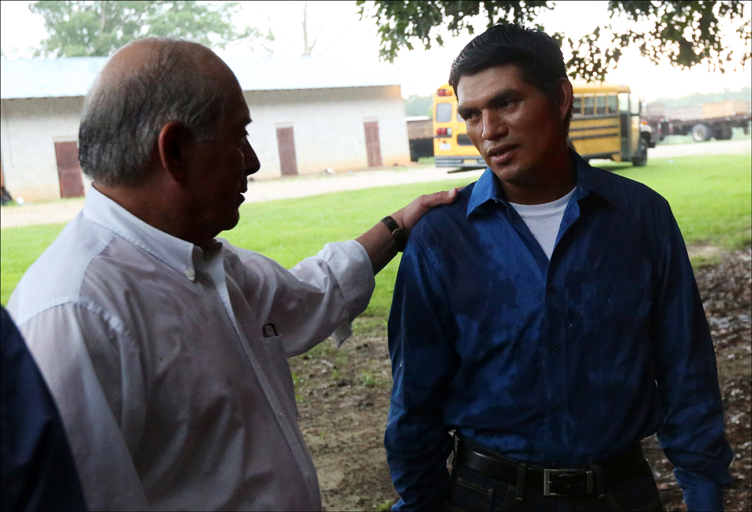  FLOC President Baldemar Velasquez, left, speaks with a migrant worker, who agreed to be photographed but declined to be named, outside the cinder block building where he lives. The union, which was founded in Ohio, has been expanding into the South.