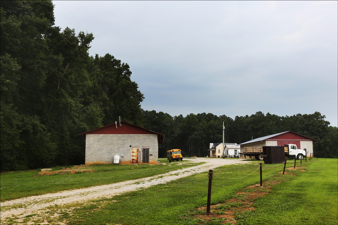 A migrant camp is tucked behind a line of trees, out of view of anyone driving along the nearby road. The Farm Labor Organizing Committee, AFL-CIO (FLOC) is working to unionize tobacco workers in North Carolina.
  