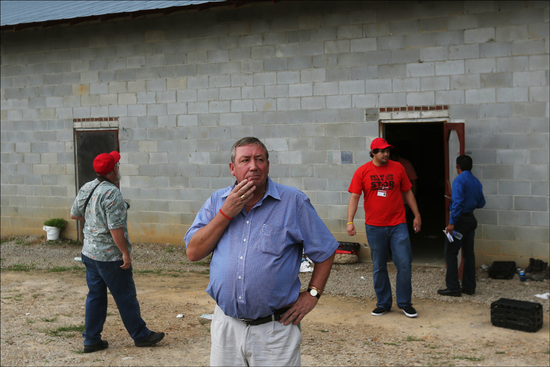  British Member of Parliament James Sheridan, center, pauses after touring the living quarters in a migrant laborer camp in between Wilson and Raleigh, N.C. Organized by the Farm Labor Organizing Committee, AFL-CIO (FLOC), Sheridan and his fellow Bri