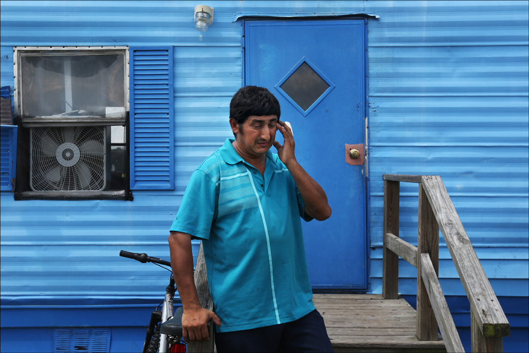  Santiago Garcia, a tobacco worker from Guatemala, pauses as he speaks of his inability to work while standing near the single wide trailer where he and four other men near Dudley, North Carolina. Garcia, who had to turn the deed to his property in G
