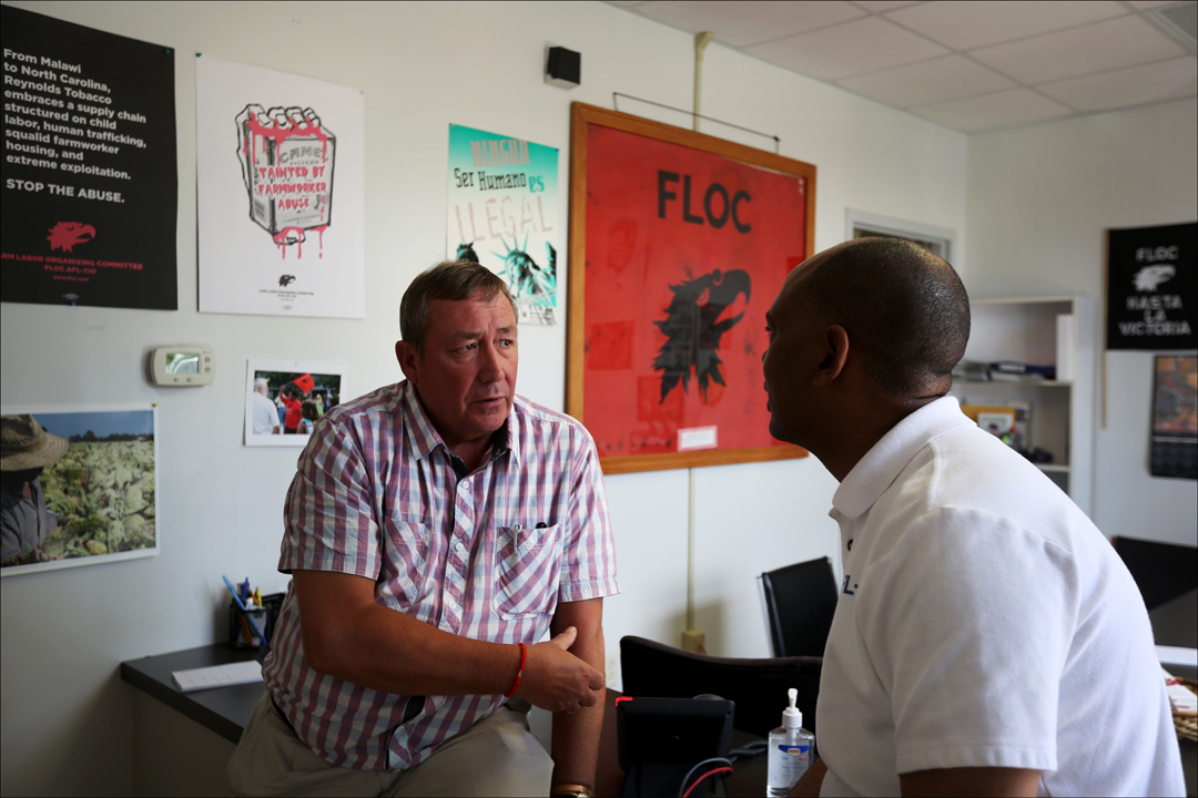  British Member of Parliament James Sheridan, left, speaks with AFL-CIO Executive Vice President Tefere Gebre share a word at the headquarters of the Farm Labor Organizing Committee, AFL-CIO (FLOC), near Dudley, North Carolina. U.S Congresswoman Marc