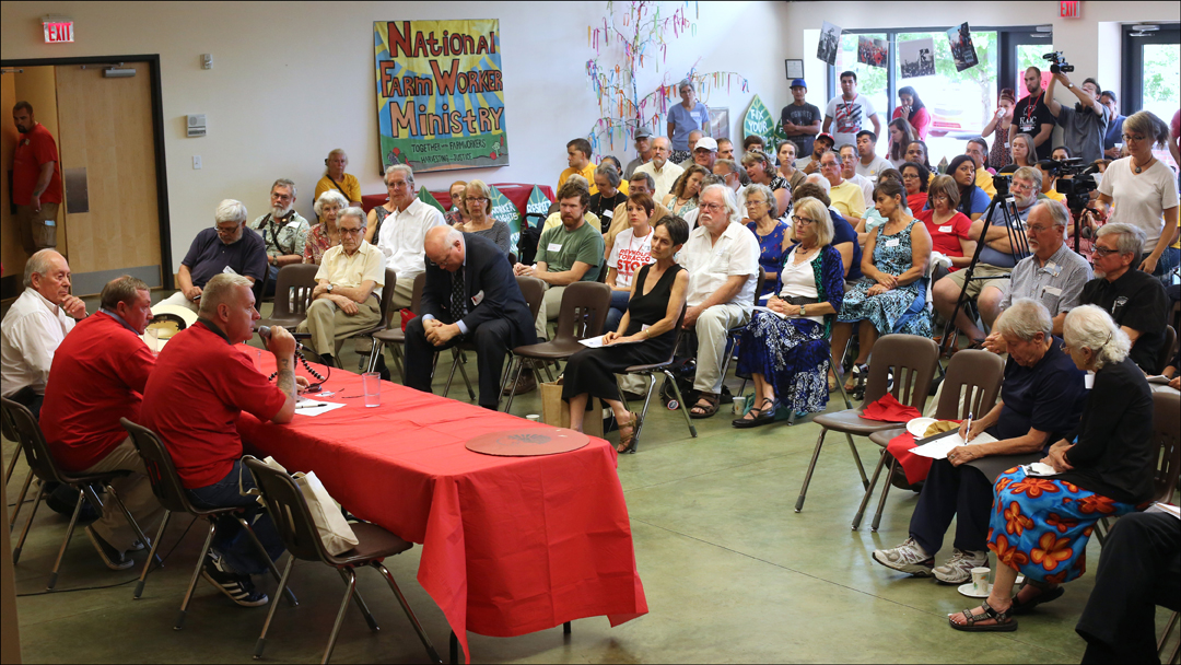  More than 100 FLOC members, supporters and allies gather Sunday, July 28, 2014, for a round table discussion with British Members of Parliament Ian Lavery, at table center, and James Sheridan, at table right, after their two-day-long tour of migrant