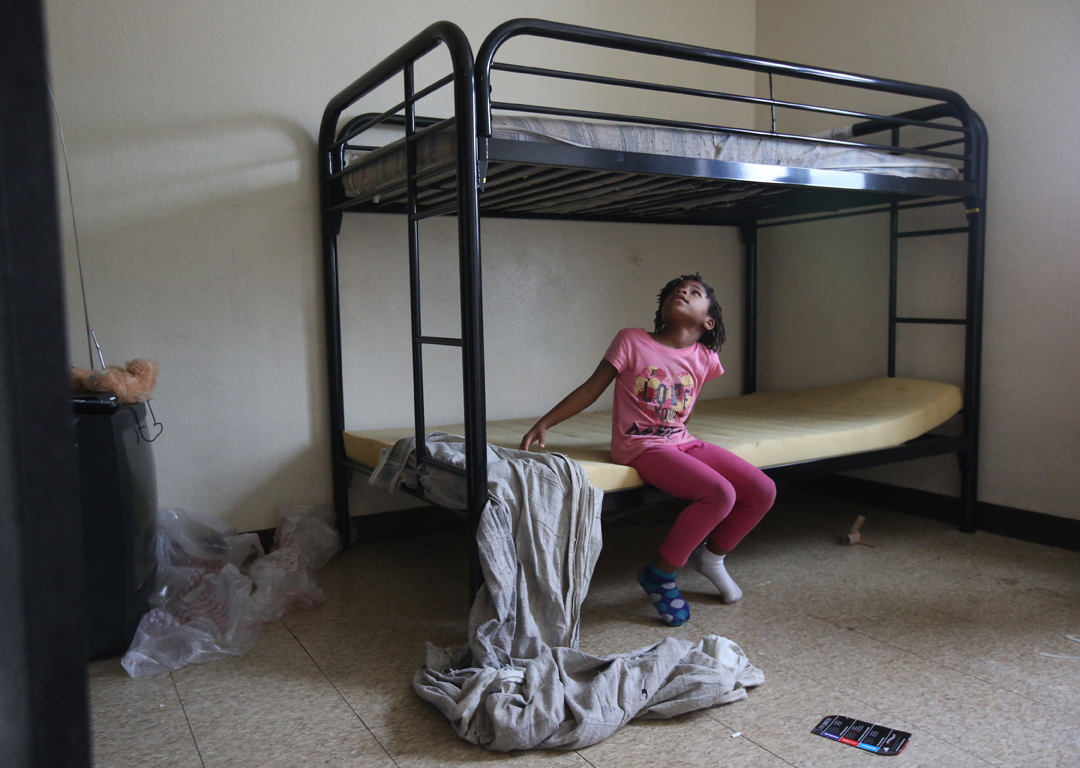  Relonna Alexander, 7, inspects her new bunk bed after it was delivered and assembled by volunteers from Extreme Results gym along with other donated furniture Friday, December 23, 2016, at Birmingham Terrace in East Toledo. Vincent Ceniceros, CEO of