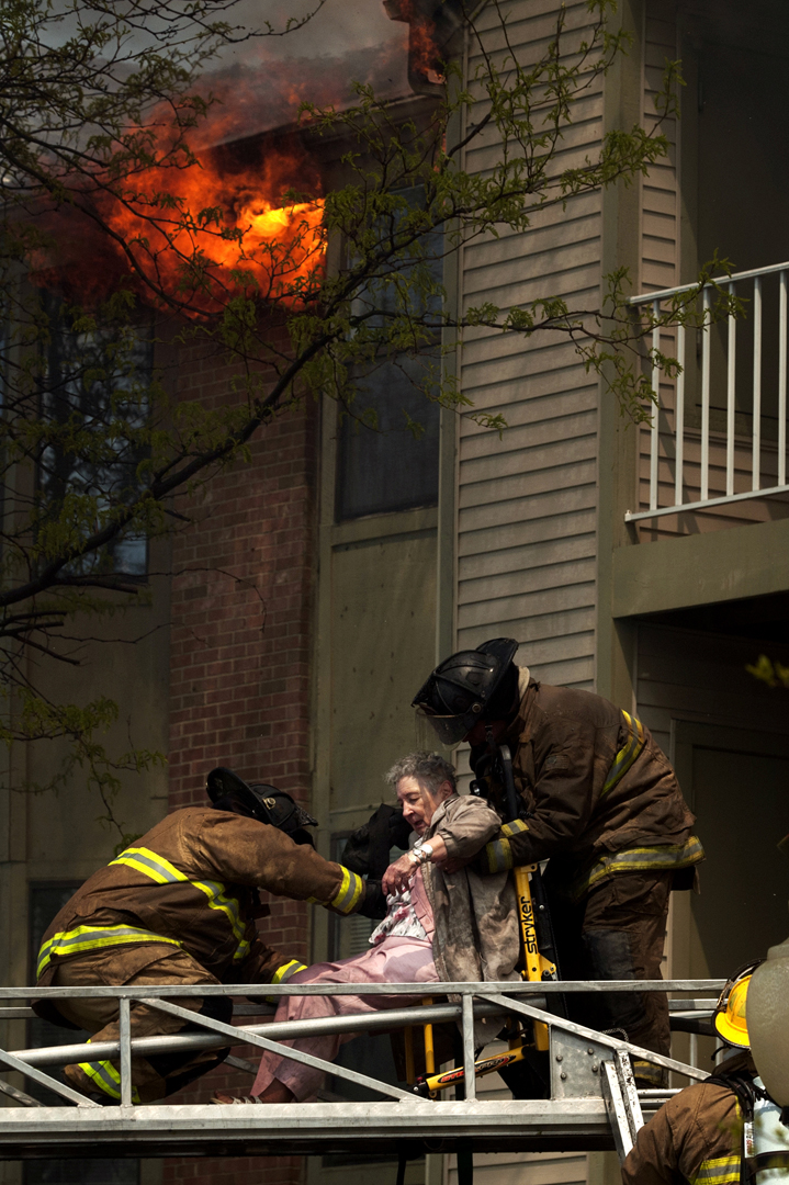  Evelyn Mackey, 91, is hoisted off a ladder as her apartment building burned behind her Sunday afternoon at Rosehaven Manor Retirement Living Community off of Atherton Road in Flint. The cause of the fire is under investigation. Though no fatalities 