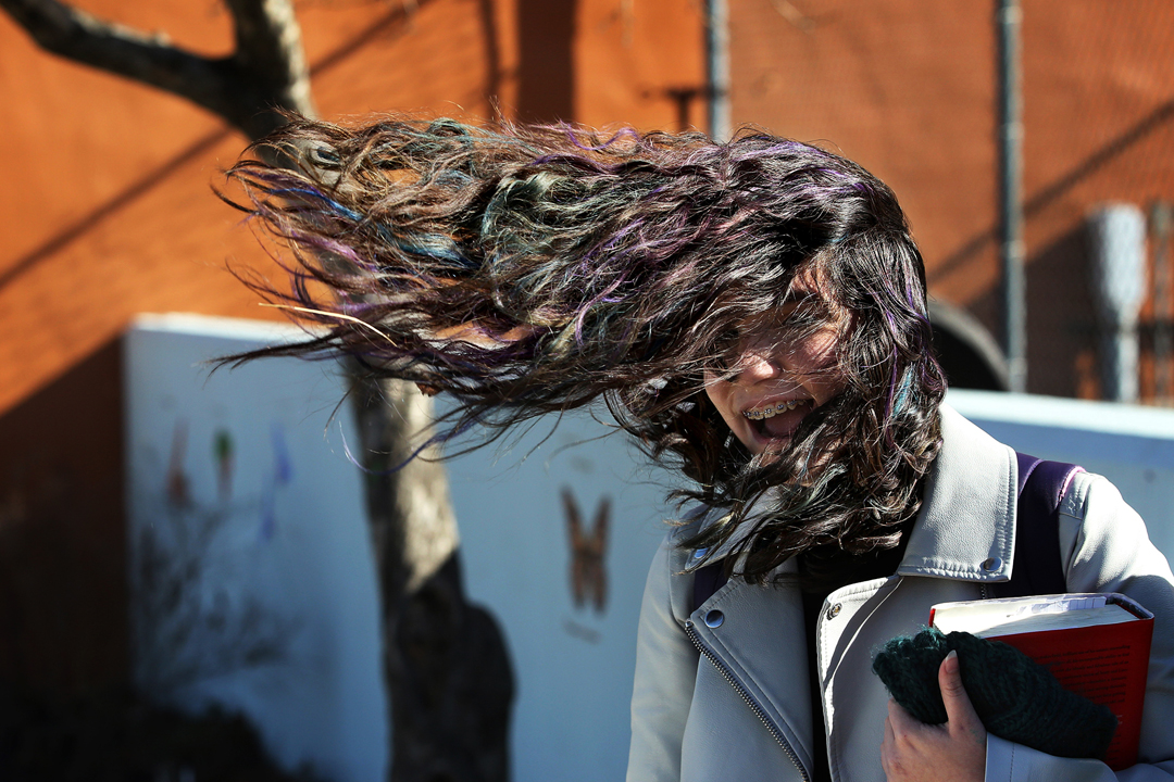  "I can't get my hair back!" Mckayla Mejia, 15, laughed as she checked her phone after school Wednesday, March 8, 2017, in central Toledo. High winds swept through the greater Toledo area Thursday. 
 