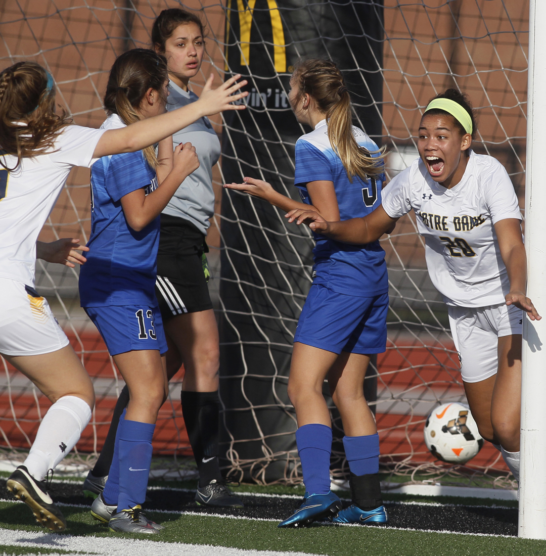  Notre Dame's Sydney Unverferth, left, rushes to cheer Lexa Bauer (20) after she scored against Brunswick's Cece Peer (13) keeper Allison Mysliwiec (5) and Emily Kazimore (3) in the second half of the Saturday, November 5, 2016, Division I Region II 