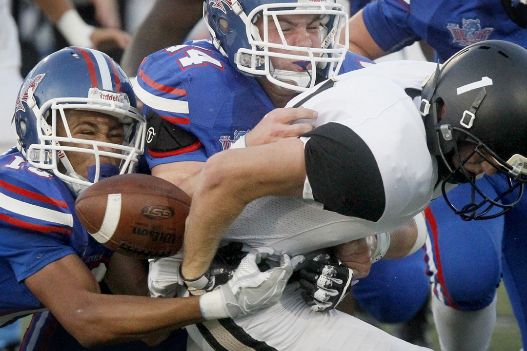  Springfield's Kevin Brake, left, and Shawn Oliver, center, force Perrysburg's Connor Meredith (1) to fumble on the tackle in the first quarter of the Friday, September 16, 2016, football match up at Springfield. Perrysburg recovered the fumble. Spri