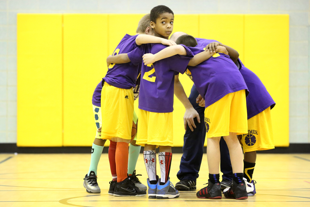  Austin Proctor, 8, center, broke from his group's huddle to look back at his opposing teammates in a scrimmage during basketball team practice at Fairfield Elementary in Maumee. The Panthers have taken to wearing colorful socks to augment their unif