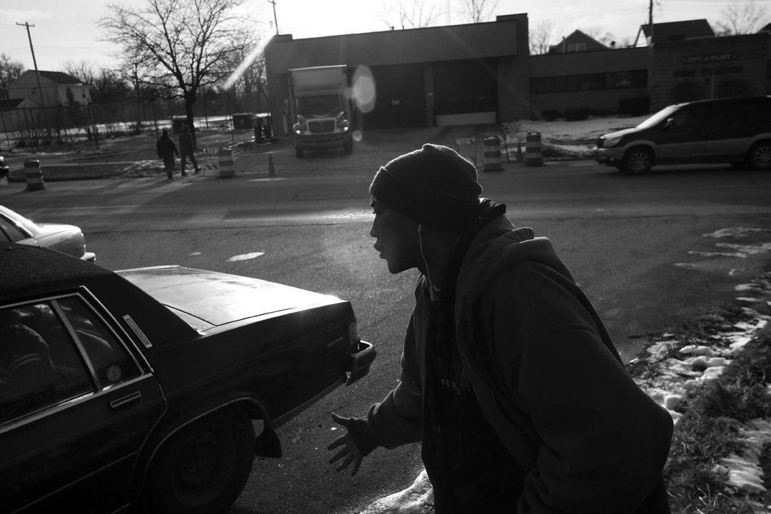  Darryl Matiere Sr., an Air Force and Air National Guard veteran, emphatically denounces Michigan Gov. Rick Snyder to fellow Flint resident Audrea Crawford, not pictured, after both came to one of the city's fire stations to pick up a case of bottled