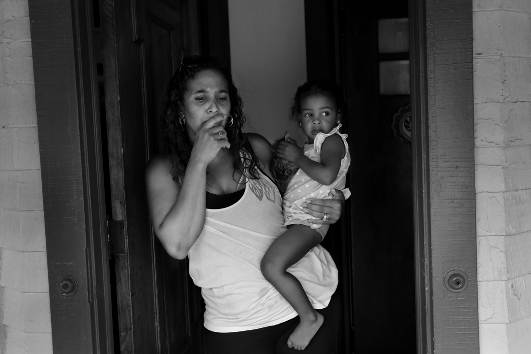  Angela Williams holds her daughter Angelina, 2, as she expresses her concerns about lead paint in her rental house in Lakewood, Ohio, on Aug. 15, 2017. The Board of Health has issued Orders of Eviction for nearly 90 in Cuyahoga County, including the