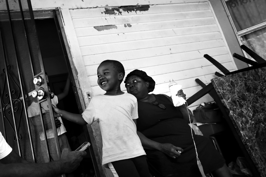  Jeremiah Slaughter, 5, left, plays on the front porch of his grandmother's house in East Cleveland, Ohio, on Aug. 16, 2017. His grandmother Brenda Slaughter, right, said her family was moving out of their rental property after nine years because the