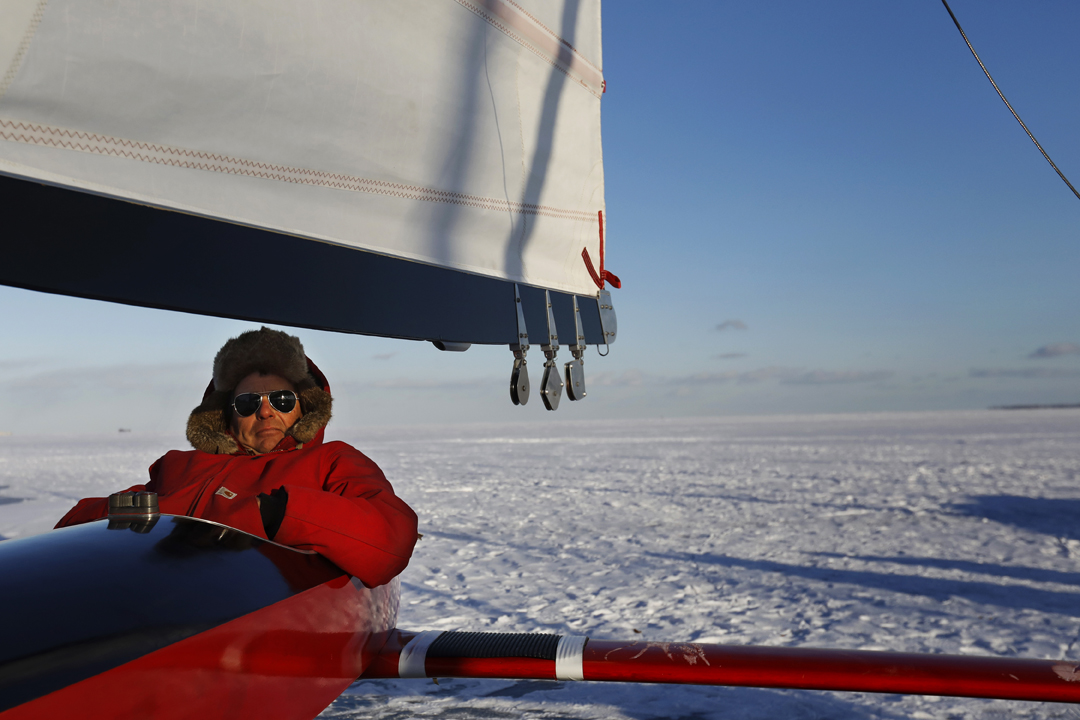 Les Lashaway, a member of the Toledo Ice Yacht Club, sits in his 1960 Renegade ice boat as the sun sets over the frozen shoreline of Lake Erie Saturday, January 6, 2018, in Point Place. Cold temperatures have helped to freeze the bays and rivers in the area, opening them up for various kinds winter sporting. The yacht club plans to race the boats Sunday, January 7, 2018.