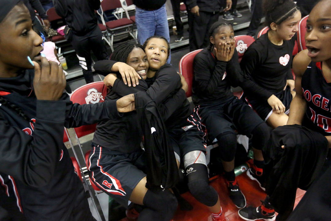  Rogers' Tanaziah Hines, center left, and Tasya Gant, center, right, embrace as their teammates celebrate after the Rams beat Gilmour Academy in the Saturday, March 17, 2018, OHSAA Division II state championship game at Value City Arena in Columbus. 