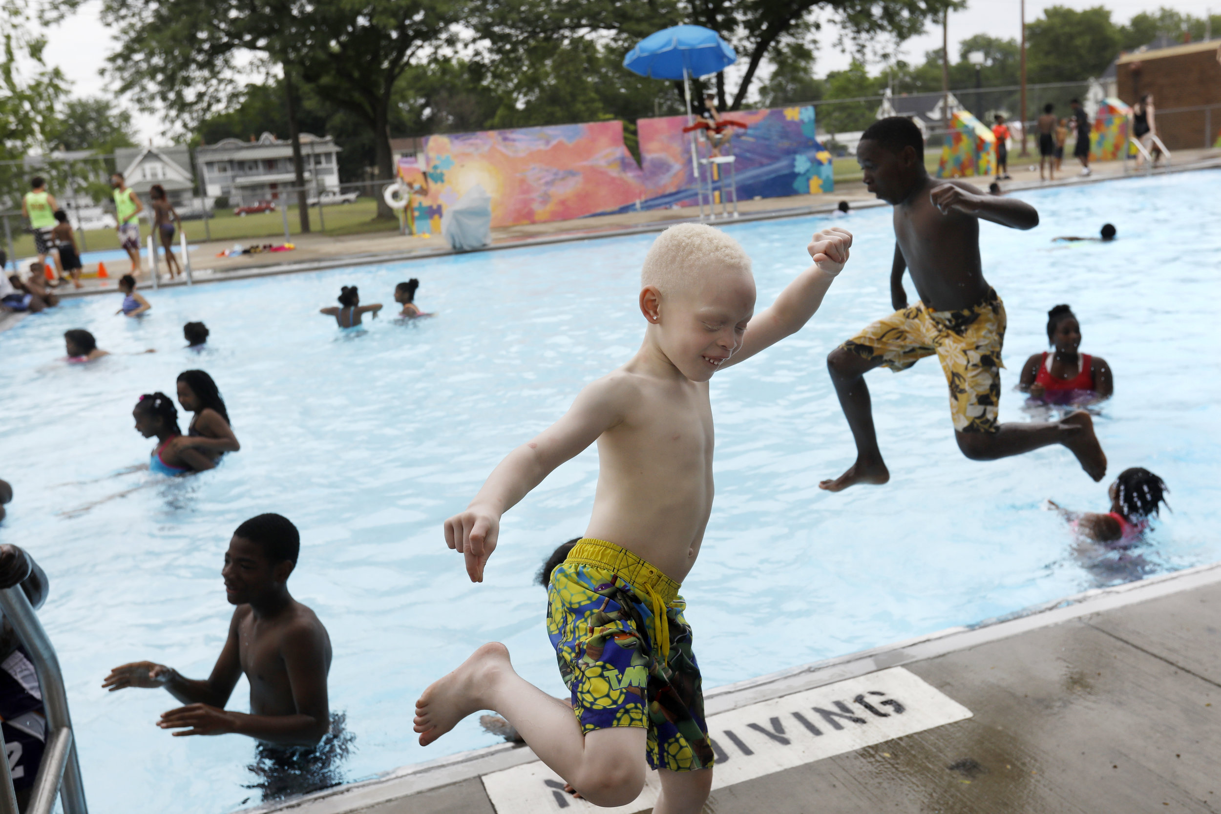 Karmero Sims, center, dances to music playing as other children jump into the newly-opened Roosevelt Pool during the seventh annual Smith Fest June 16, 2018, in Smith Park in Toledo. The festival featured horse rides from the Toledo Horsemen Club, a number of sports lessons, the opening of Roosevelt Pool, and a bike give-away.