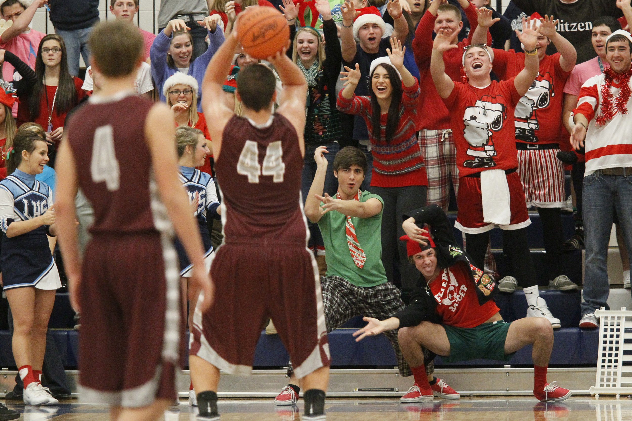  Lake seniors Forrest Bennett, 17, center, and Casey Blank, 17, right, lead the student section as they attempt to distract Rossford's sophomore Nate Childress during a free throw in the the second quarter of the game at Lake High School on Dec. 18, 