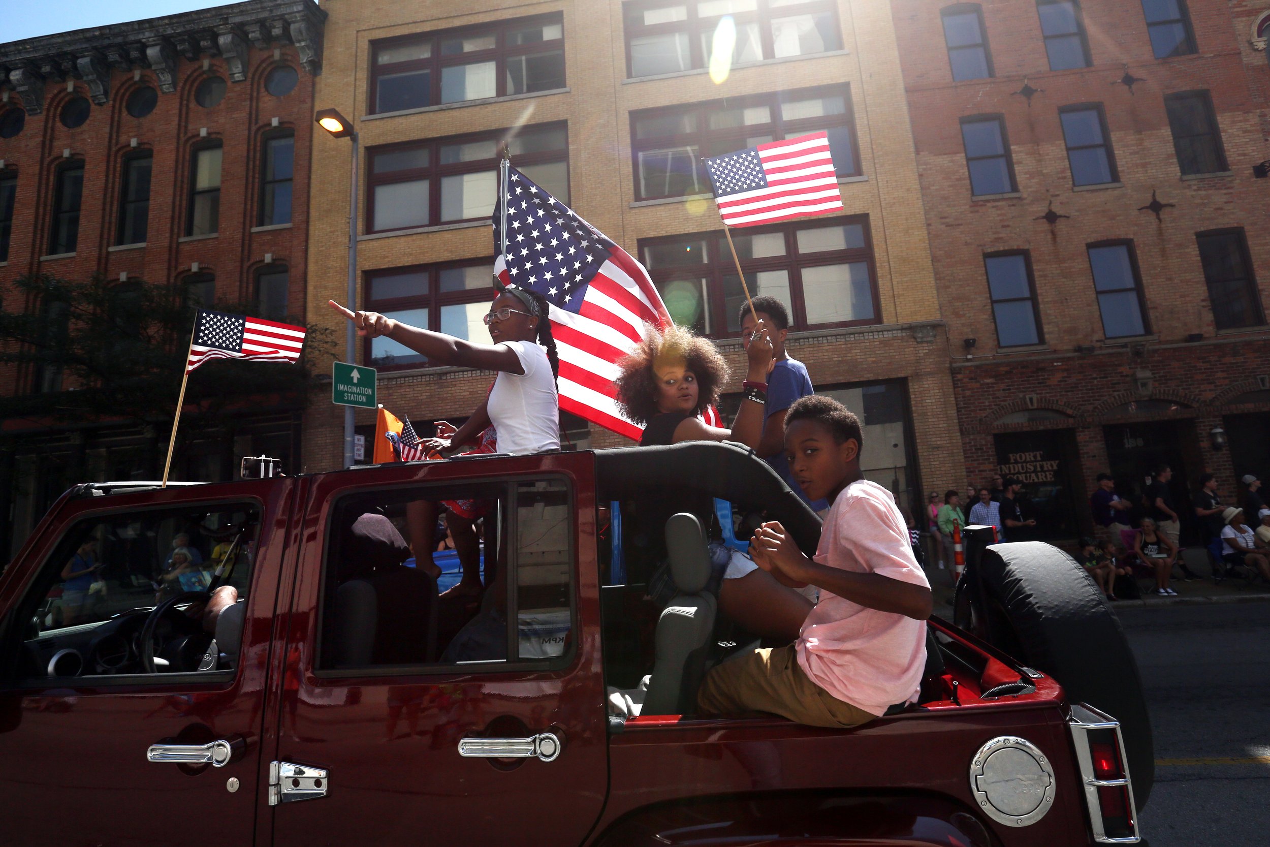  A Jeep rolls by with cheering riders at the second Toledo Jeep Fest parade in downtown Toledo, Ohio, on Saturday, August 11, 2018. More than 1,300 Jeeps rolled through downtown in the parade, and the afternoon included food, live music, Jeeps parked