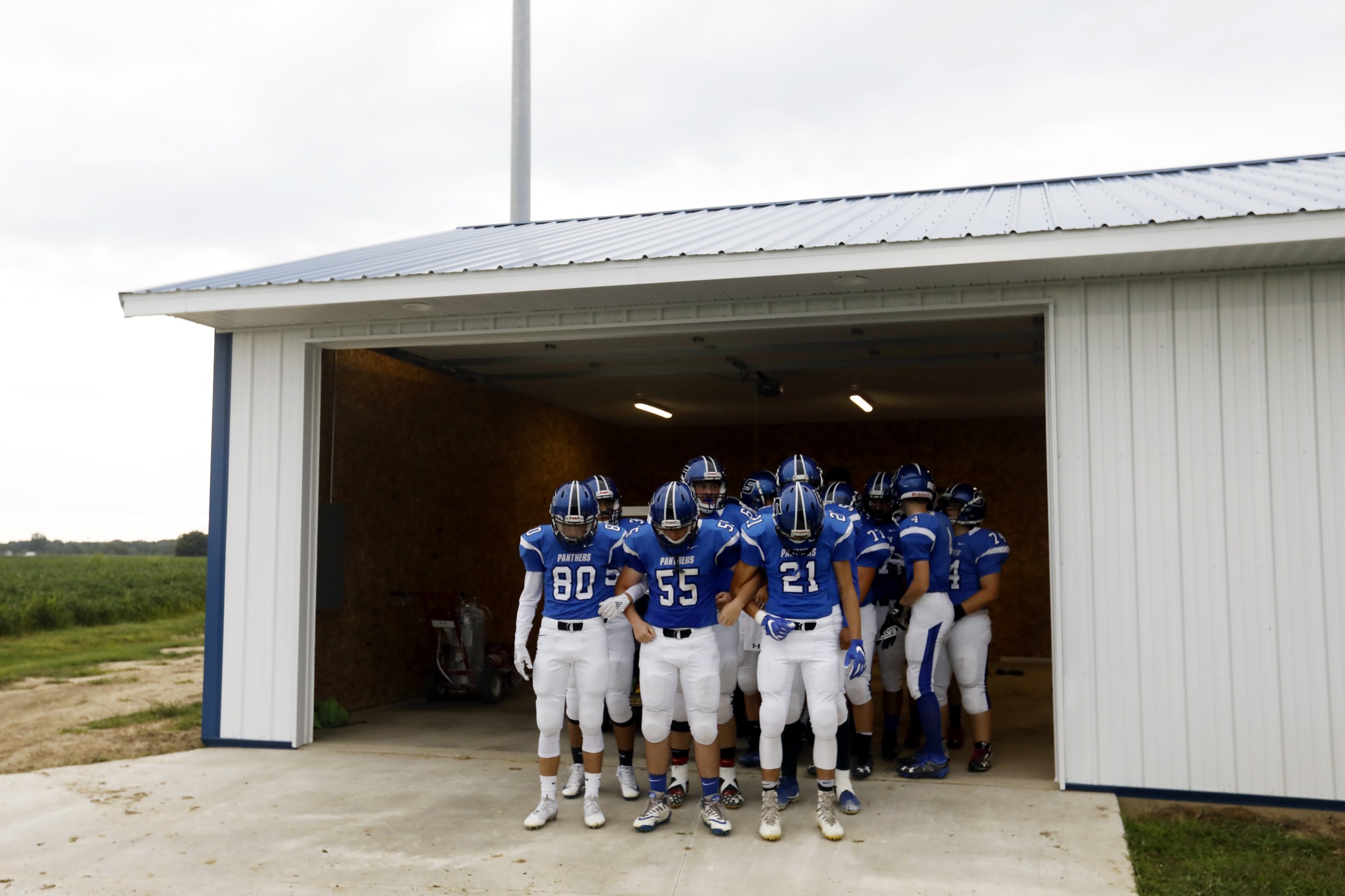  The Stryker football team is led by Max Wonders (80) Alex Grice (55) and Wyatt Short (21) as they take the field for their season home opener Friday, August 24, 2018. This was the first varsity game for the high school since 1931. The team began wit