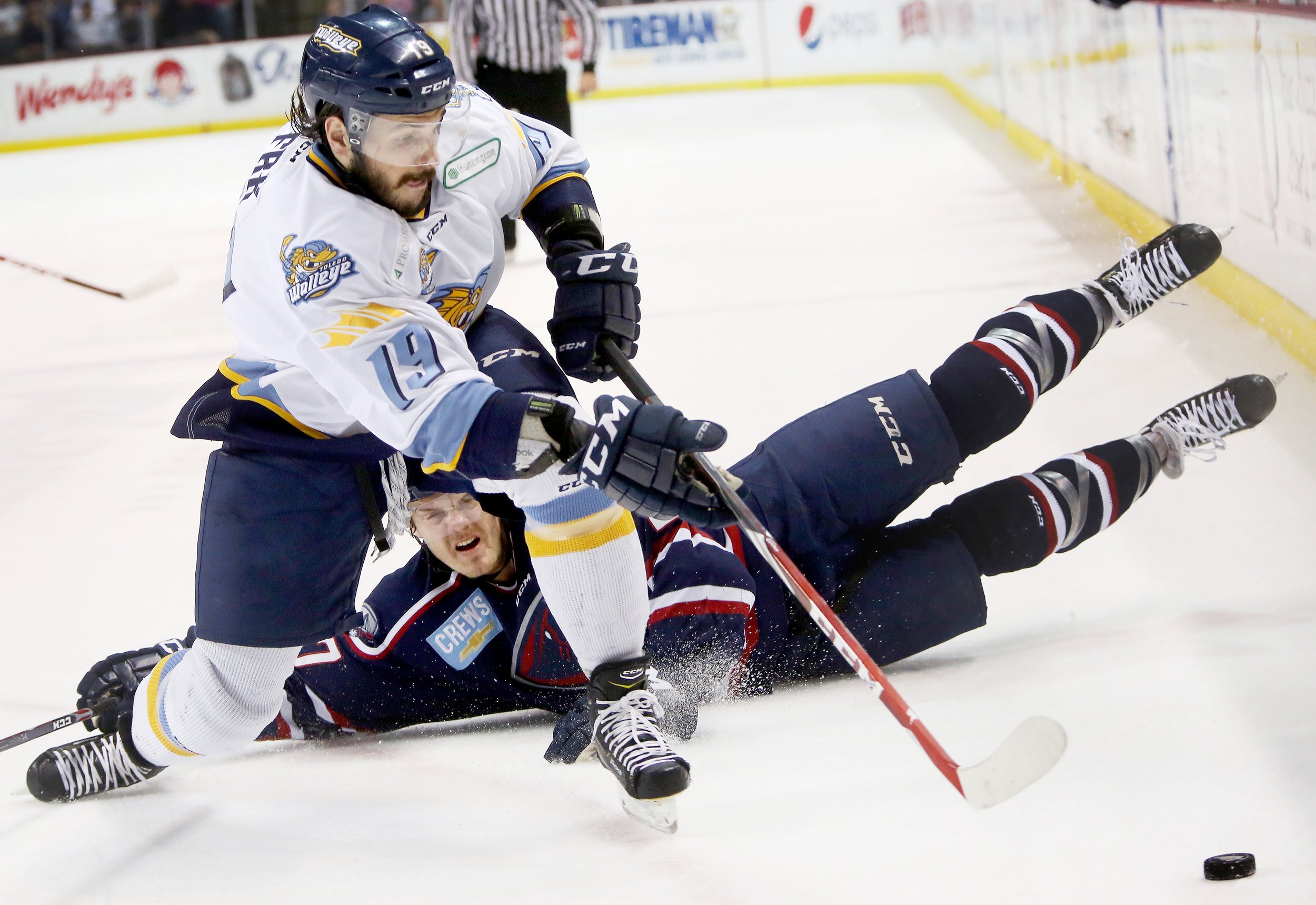  Toledo Walleye Martin Frk (19) bypasses fallen South Carolina Stingrays defender Wade Epp (27) in pursuit of the puck during the first period of the series Game 6 match up at the Huntington Center in downtown Toledo, Ohio, on May 26, 2015. 