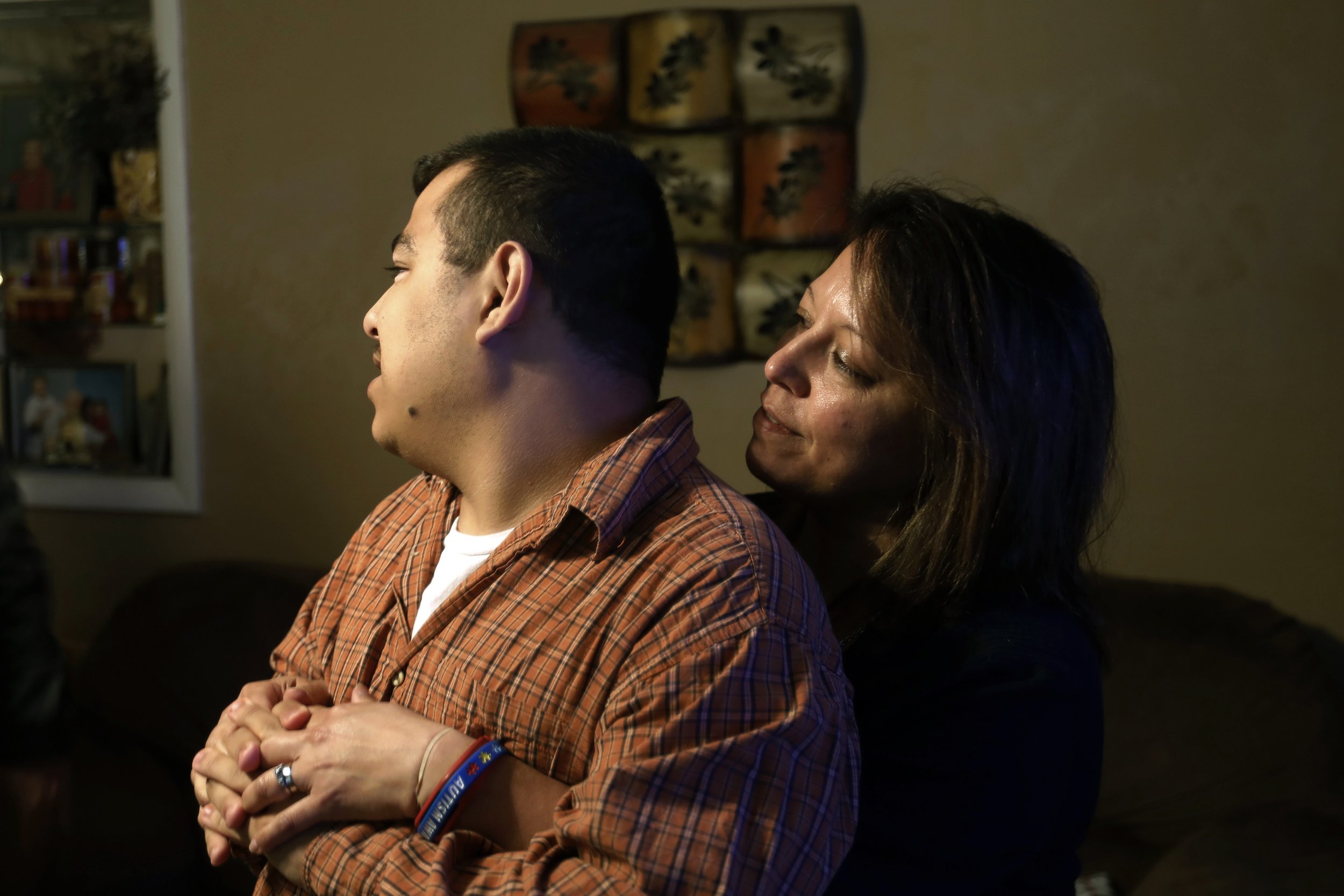  Jenny Hughes hugs her son Gabe, 23, as they stand in their living room in Walbridge, Ohio, on May, 11, 2018. Jenny has two sons on the autism spectrum who are mostly nonverbal, including Gabe. She was concerned about their possible interactions with