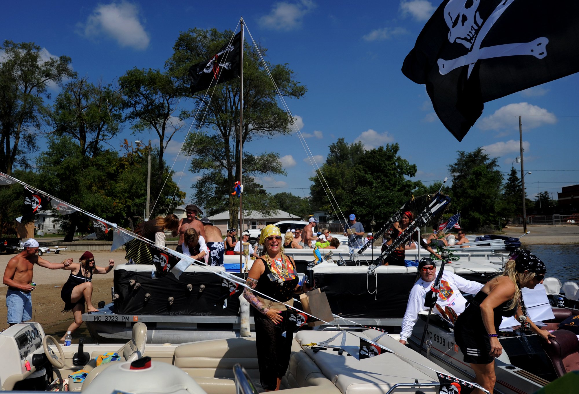  Mary Shannon of Michigan Center, Mich., center, laughs while she and other participants board their boats shortly before the start of a pirate-themed scavenger hunt at Michigan Center Lake on Sept. 5, 2009. This is the first time the scavenger hunt 