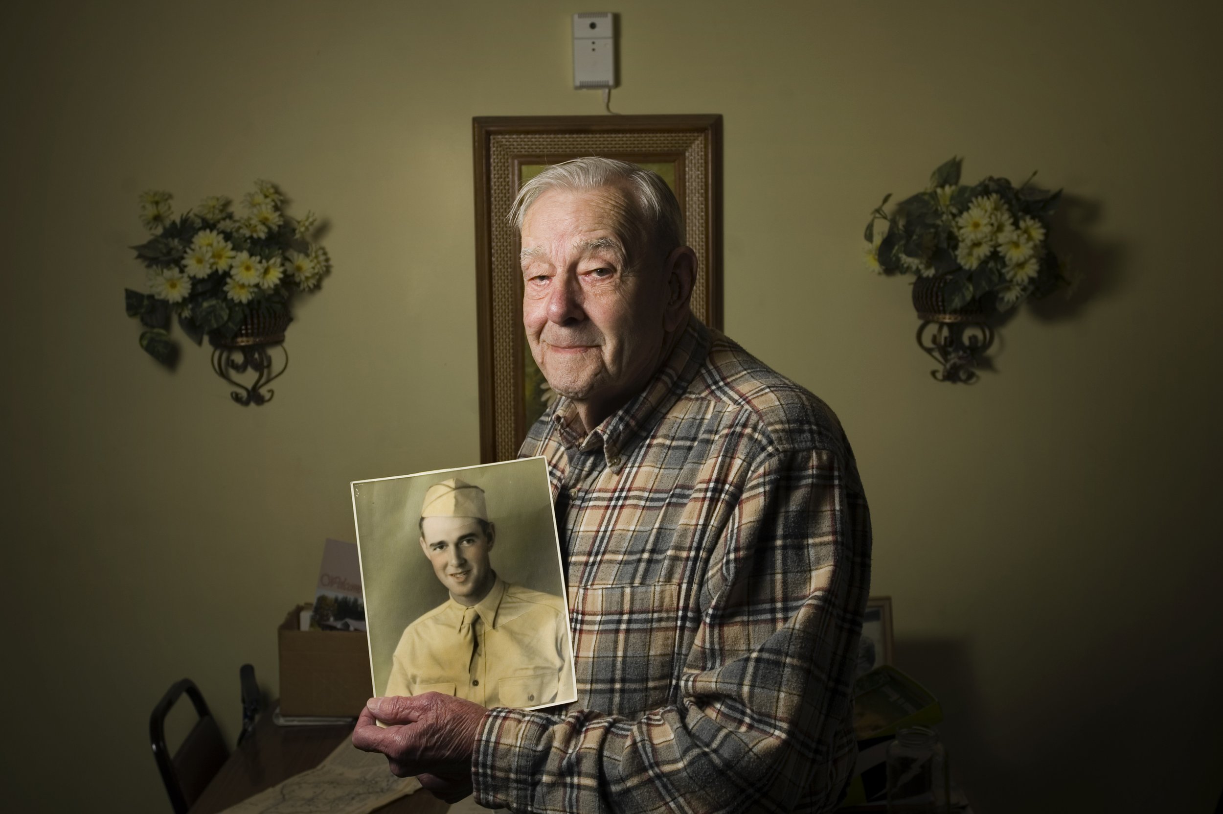  Ival Hendrick, 93, holds a photograph of himself taken a few months before the attack on Pearl Harbor in 1941. Hendrick was stationed near the harbor when the Japanese attacked. The truck he caught on the way to the harbor got stuck in the road, lea