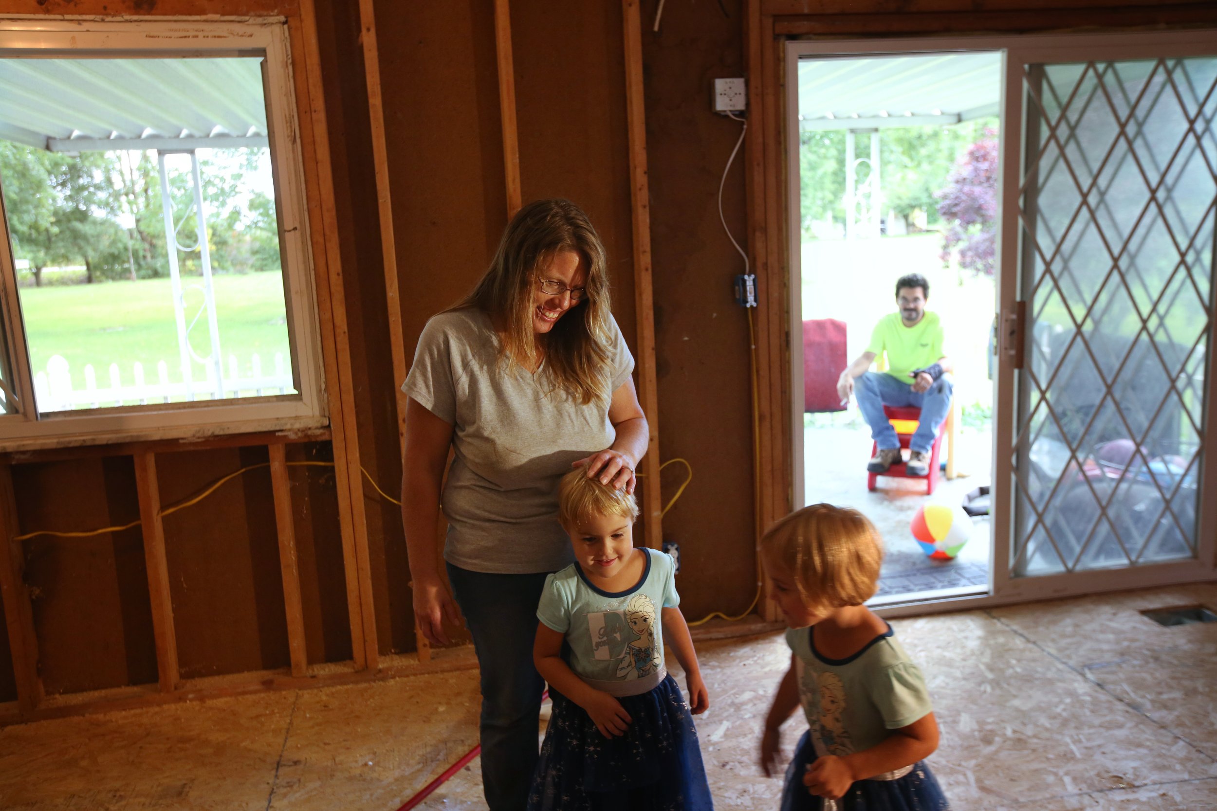 Josianne Thomas laughs as she and her husband Mike, right, take a break from renovating their new home on Sept. 17, 2016. Josianne and her twin 4-year-old daughters survived the same attack that claimed the lives of her two eldest children, and afte
