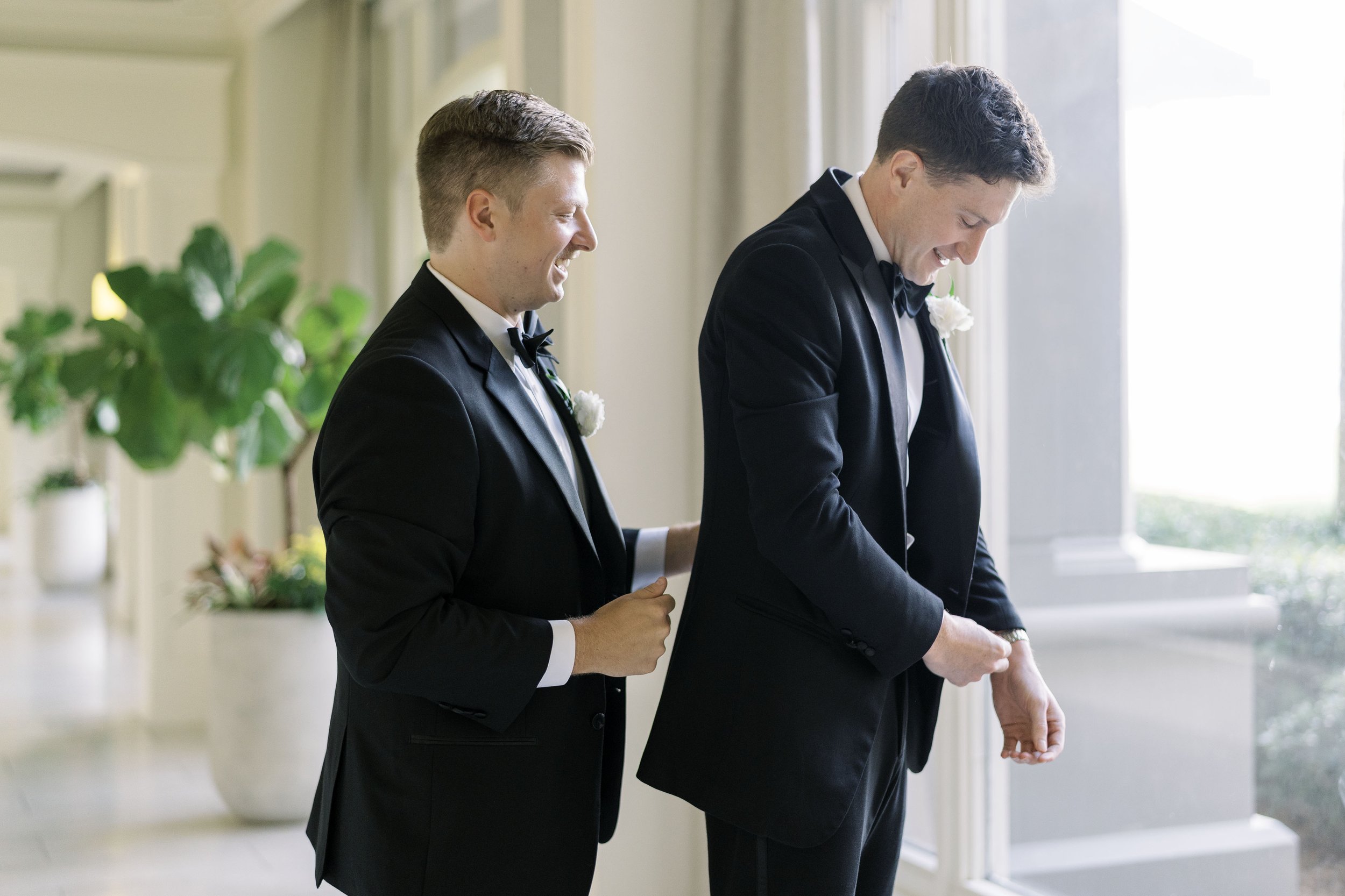 groom and groomsmen getting ready at the ritz carlton white hallway in fernandina beach fl.jpg